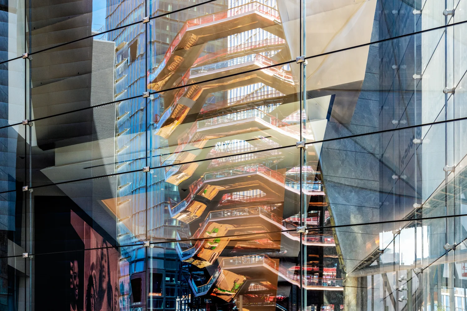 Vessel (TKA) reflected in the facade of 10 Hudson Yards during construction. Dev. Related Companies & Oxford Properties