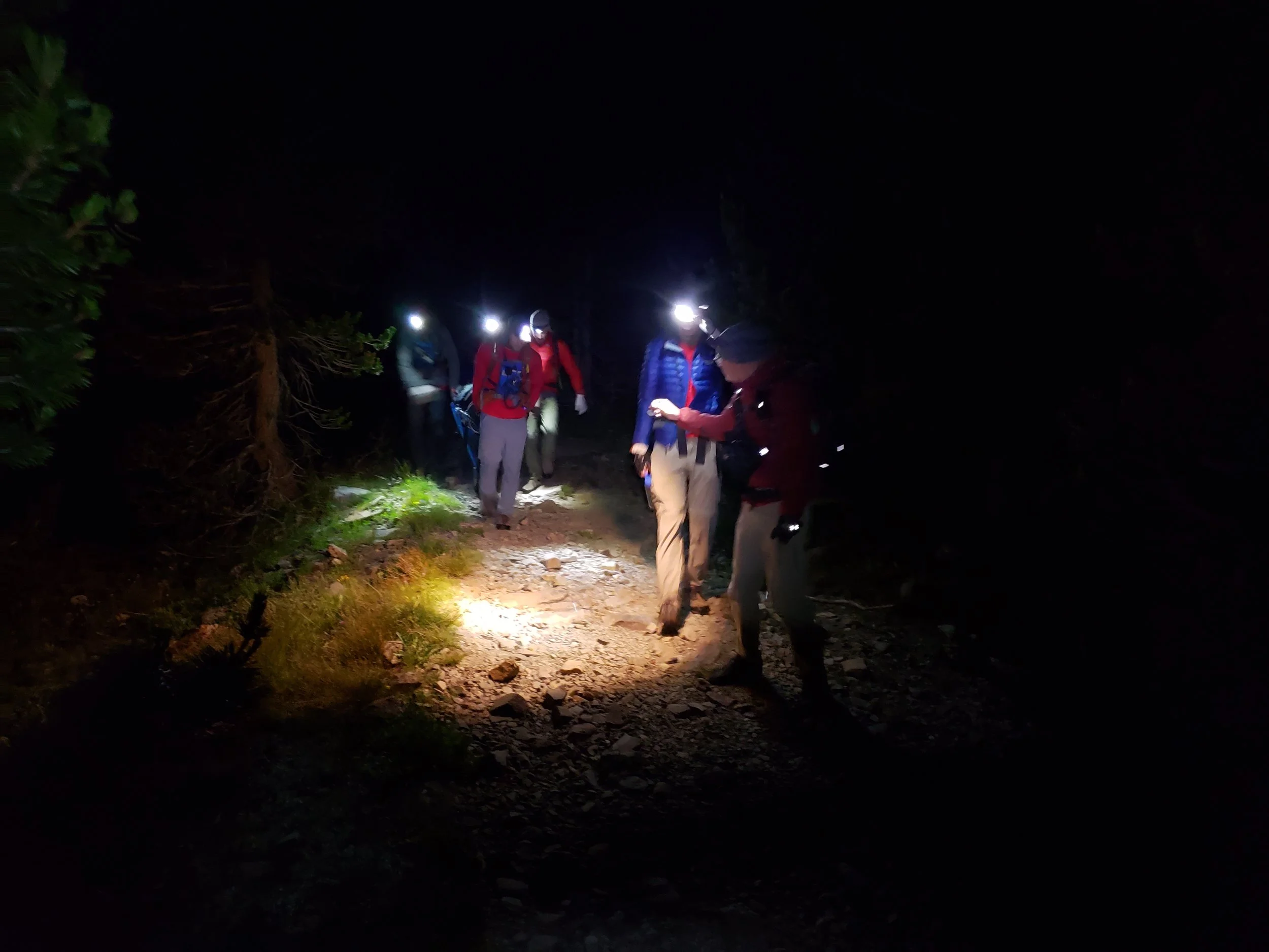 Rolling the litter down the dark and quiet trail back to the lake and the return boat ride. Image by B. Beck