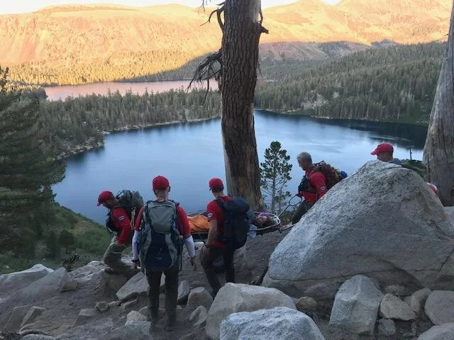 Rolling the litter down the Crystal Lake trail above Lake George. Image by D. Firer