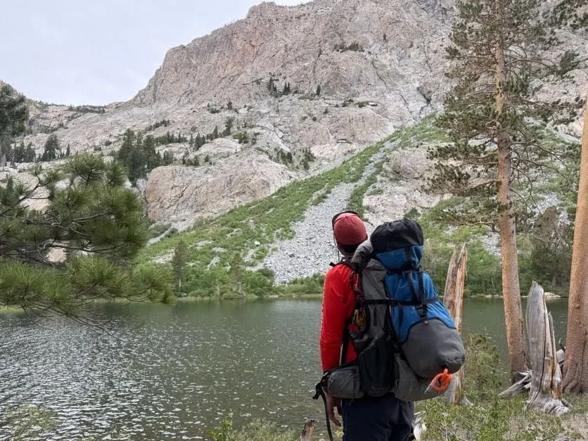 A Mono SAR rescuer looks toward the cliffs above Fern Lake