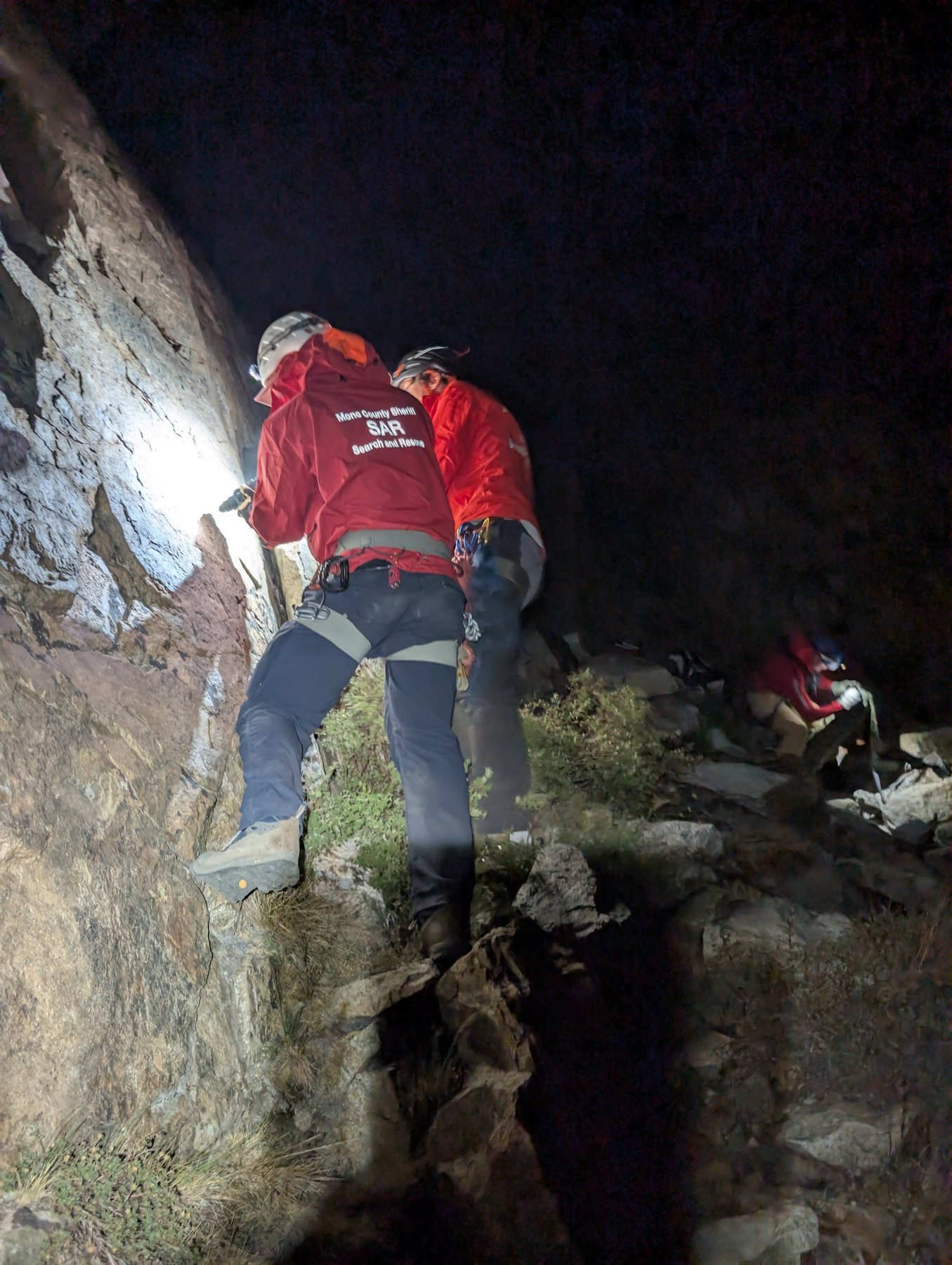Mono SAR rescuer climbs steep rock by headlamp