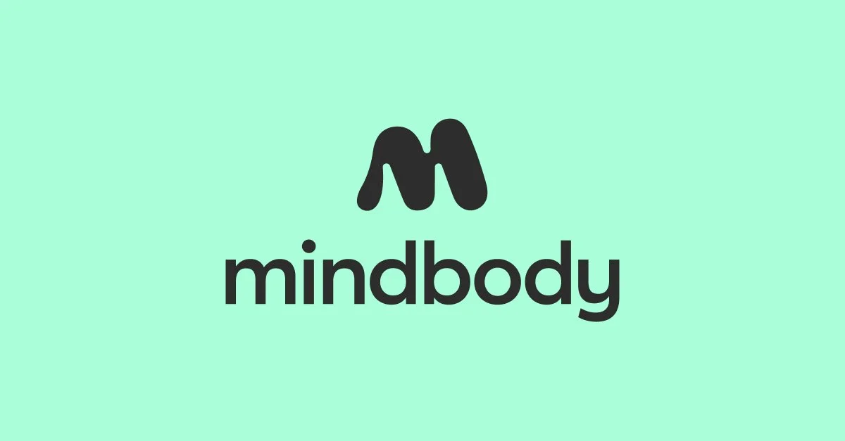 Mindbody logo with a stylized black 'M' above the word 'mindbody' on a light green background.