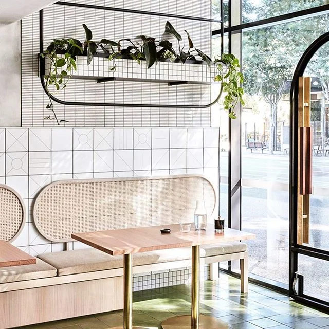 Cafe NAIM :: Plants and materials combined in the best kind of way for this cafe in Brisbane. 🌿 The very clever @thestellacollective drew inspiration from Syria’s ancient internal courtyards and tea houses for the aesthetic of this middle eastern cafe @naimonmelbourne Subtle cues of geometric tiles and arched doorways hint at their modern take on middle eastern design. THAT bench seat with custom planter above 😳 😳 there’s beauty in the details. Images Via @yellowtrace