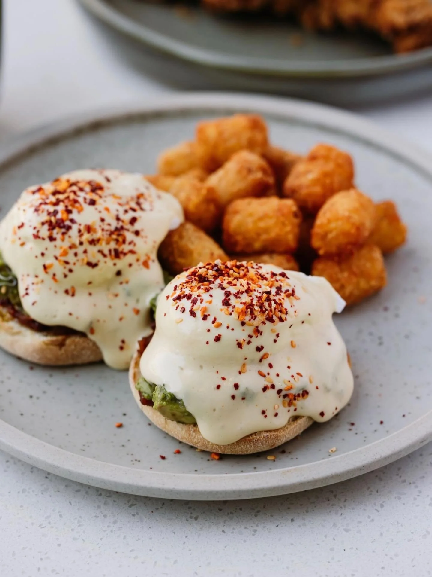🥑 avocado benedict 🥑 poached eggs, avocado, tomato jam, chili crunch, hollandaise, tots #theirhere