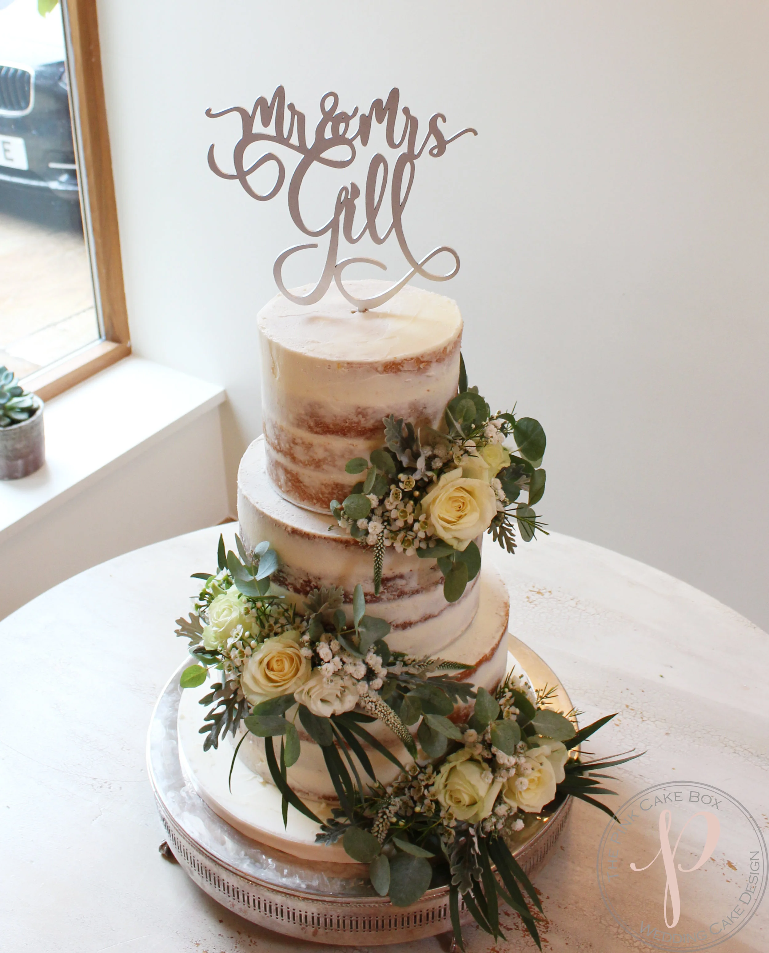 semi naked wedding cake foliage and cream roses beautiful rustic.jpg