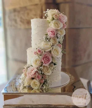 Buttercream wedding cake summer flowers cascade