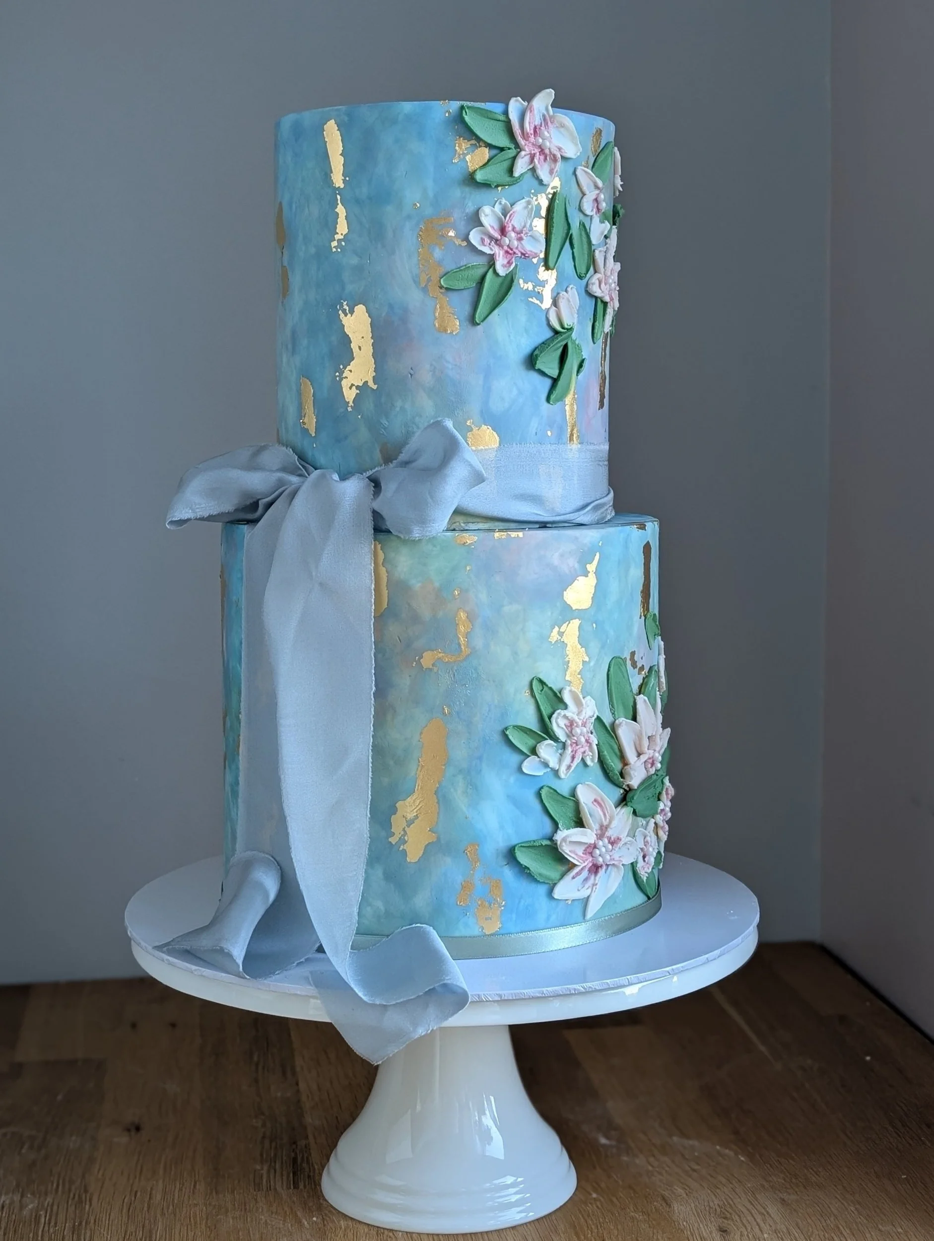 Blue watercolour 2 tier wedding cake with palette flowers