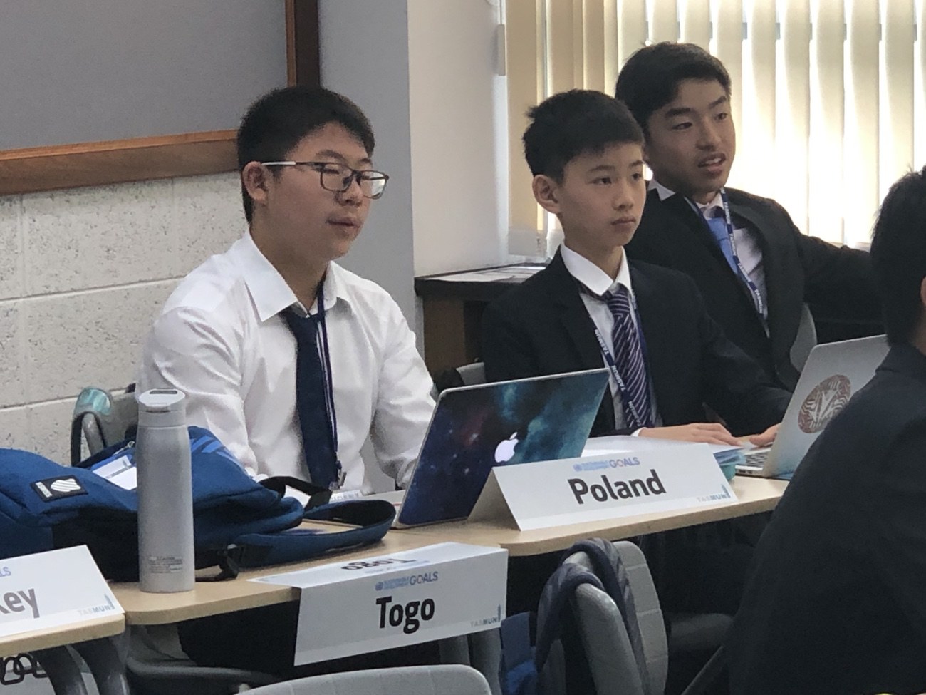 Jimmy Q., an eighth grade Concordia delegate represents Togo with Evan Chua representing Poland on the issue of global warming. (image supplied)
