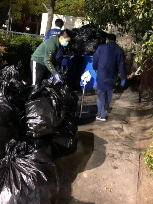 Members of the Global Development Studies trash audit team weigh garbage at the end of a school day.