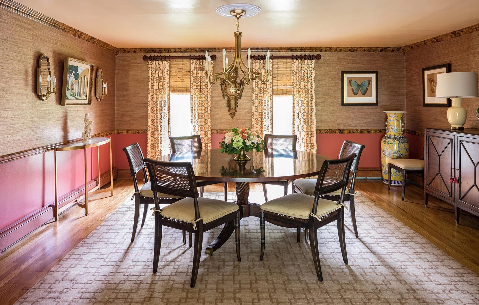 Warm dining area with round dining table for six and printed carpet