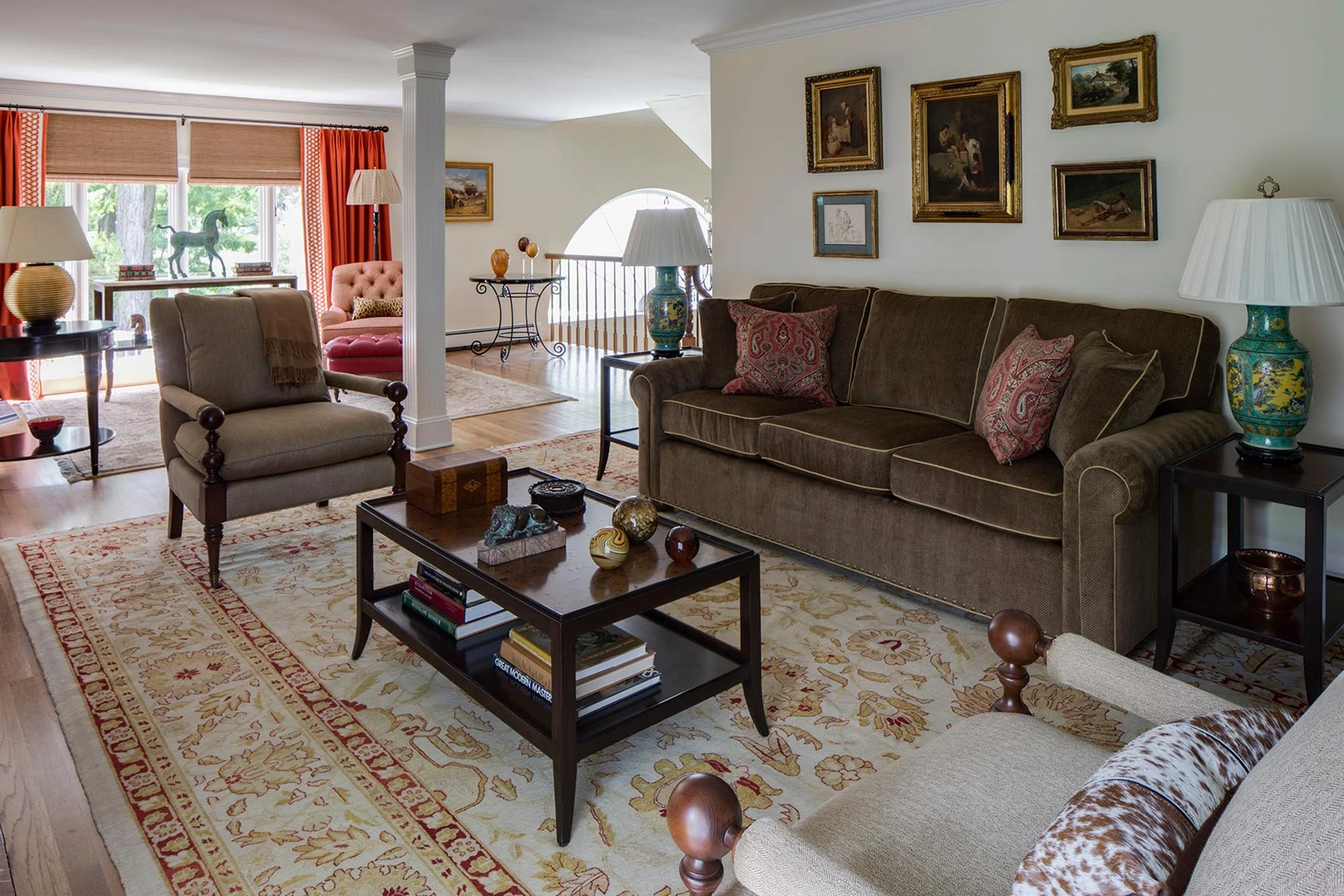 Bright living room with brown couch and sofa and printed carpet
