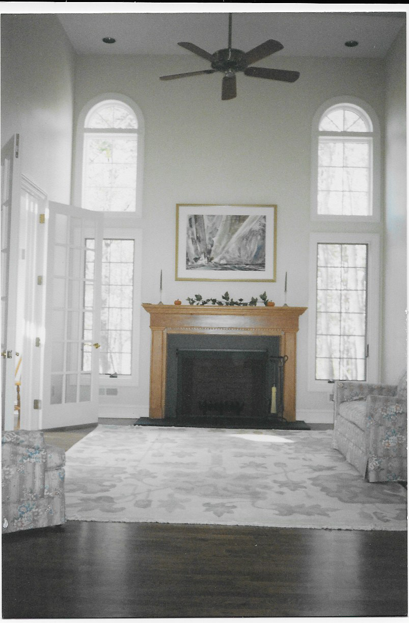 Living room with high ceiling and fireplace