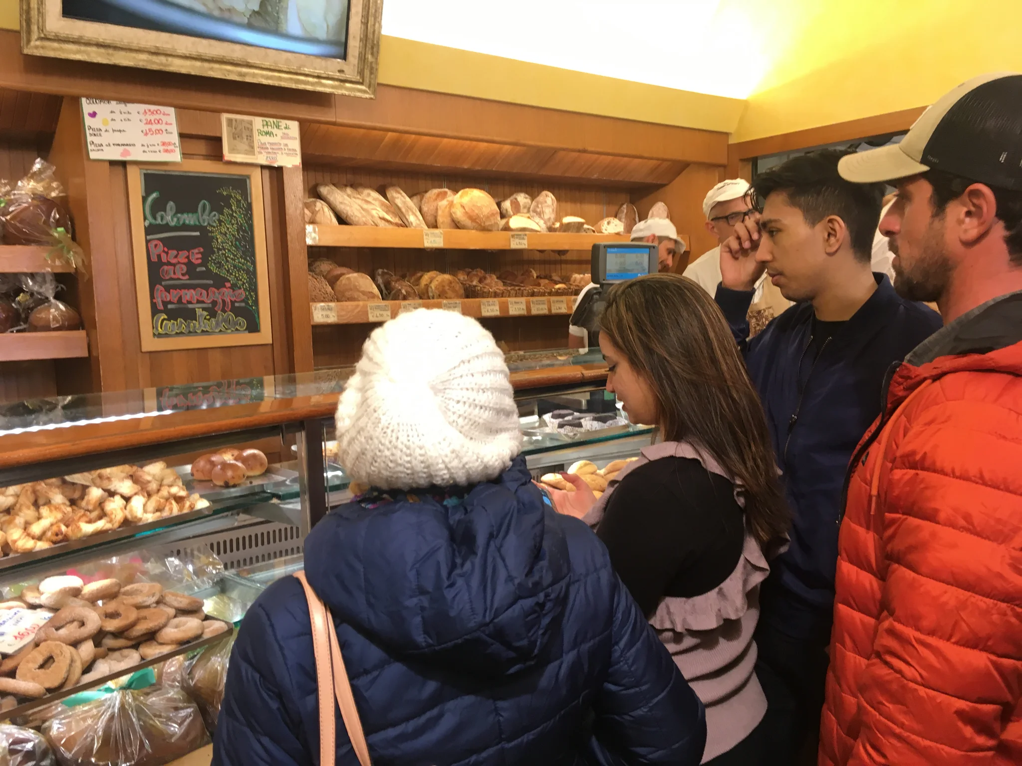 Golf-cart tour of Roma: Bakery stop at Forno Campo de’ Fiori with guide Lorenzo (orange jacket)