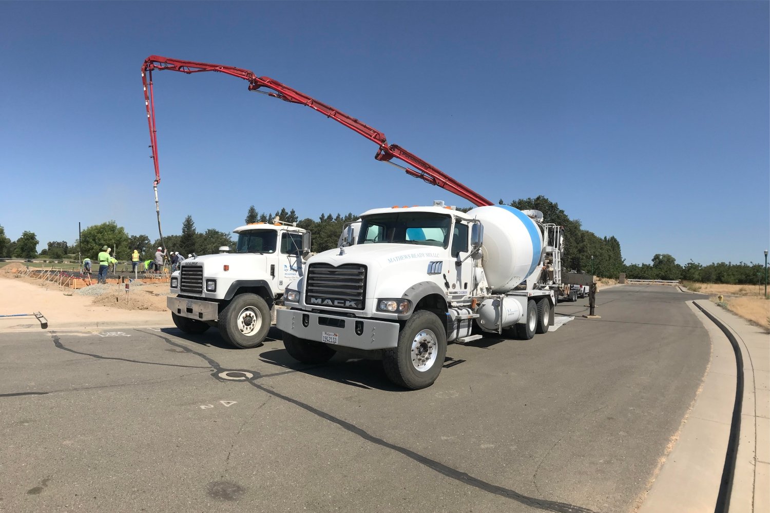 two mathews readymix cement trucks parked side by side.v2.jpg