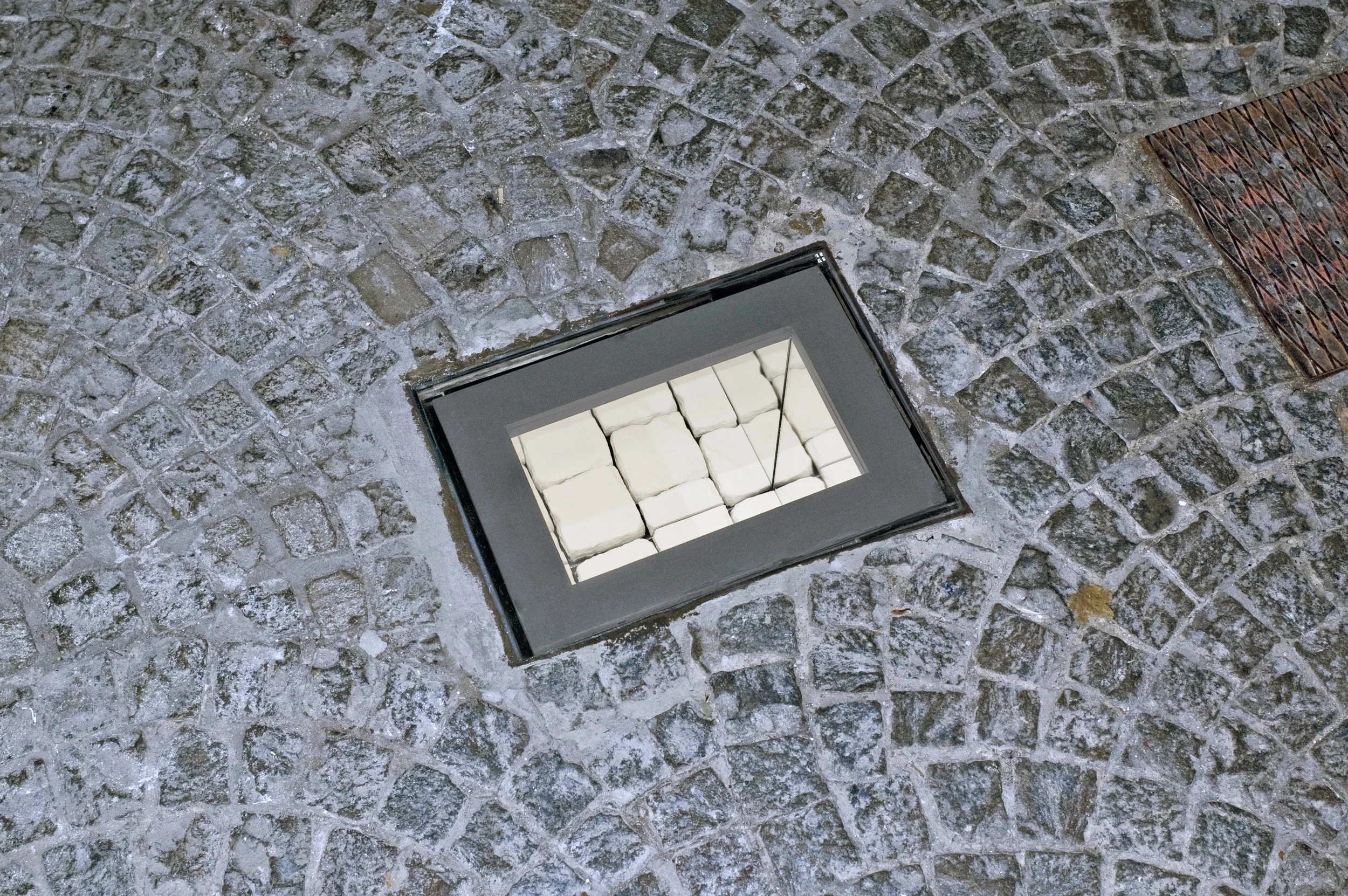  To replace "the beach" by "the cobblestones" introduce both a tragic and comedic effect. The romantic ideal of revolution is bound to fail. Art that aspire to change the world is bound to fail. Under the road lays another road, even harder to reach.