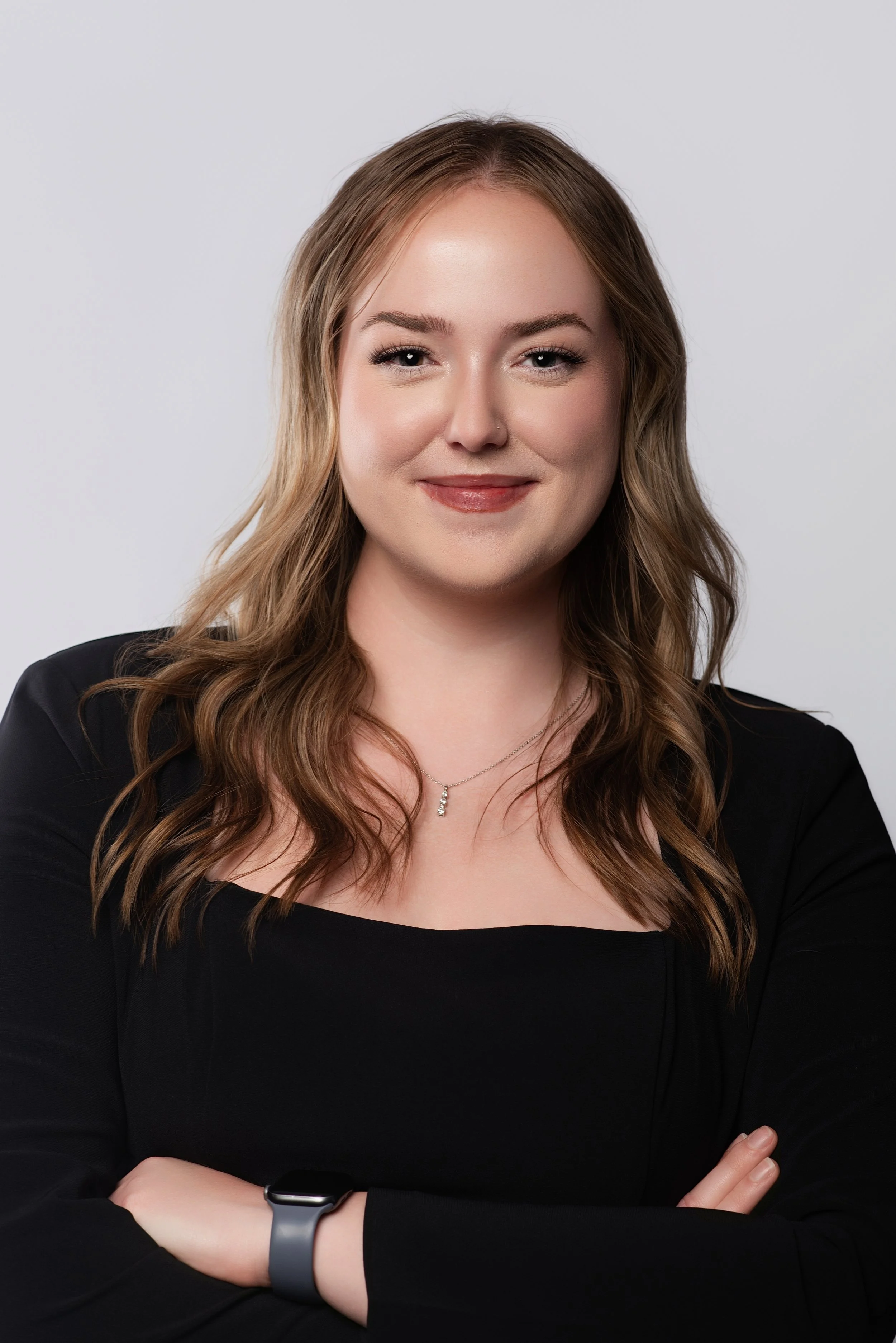  In studio headshot of a woman on a white backdrop for her employers website. 