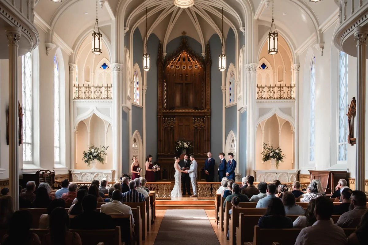 A man and woman are getting married inside Providence Academy Chapel in Vancouver, Washington.