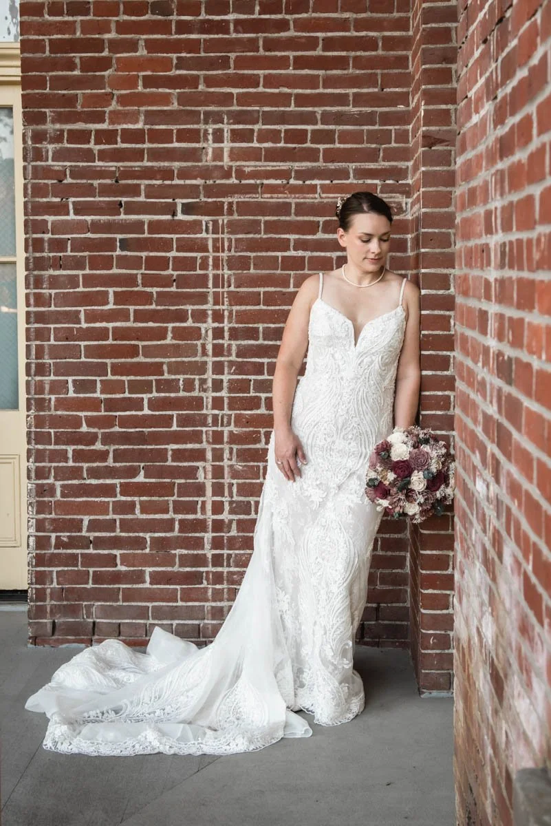A bride is posing for portraits after getting married at Providence Academy Hall & Chapel in Vancouver, Washington.