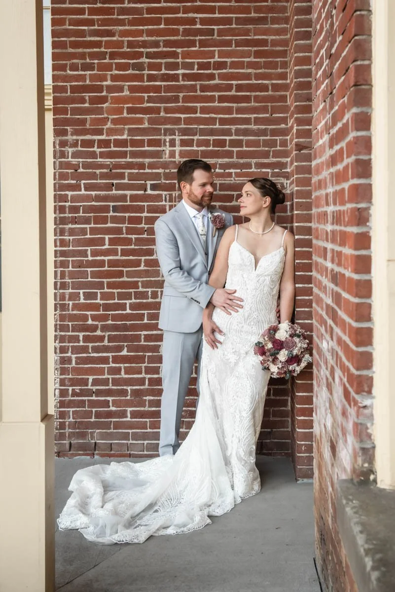 A bride and groom are looking at each other lovingly after getting married at Providence Academy Hall & Chapel in Vancouver, Washington.