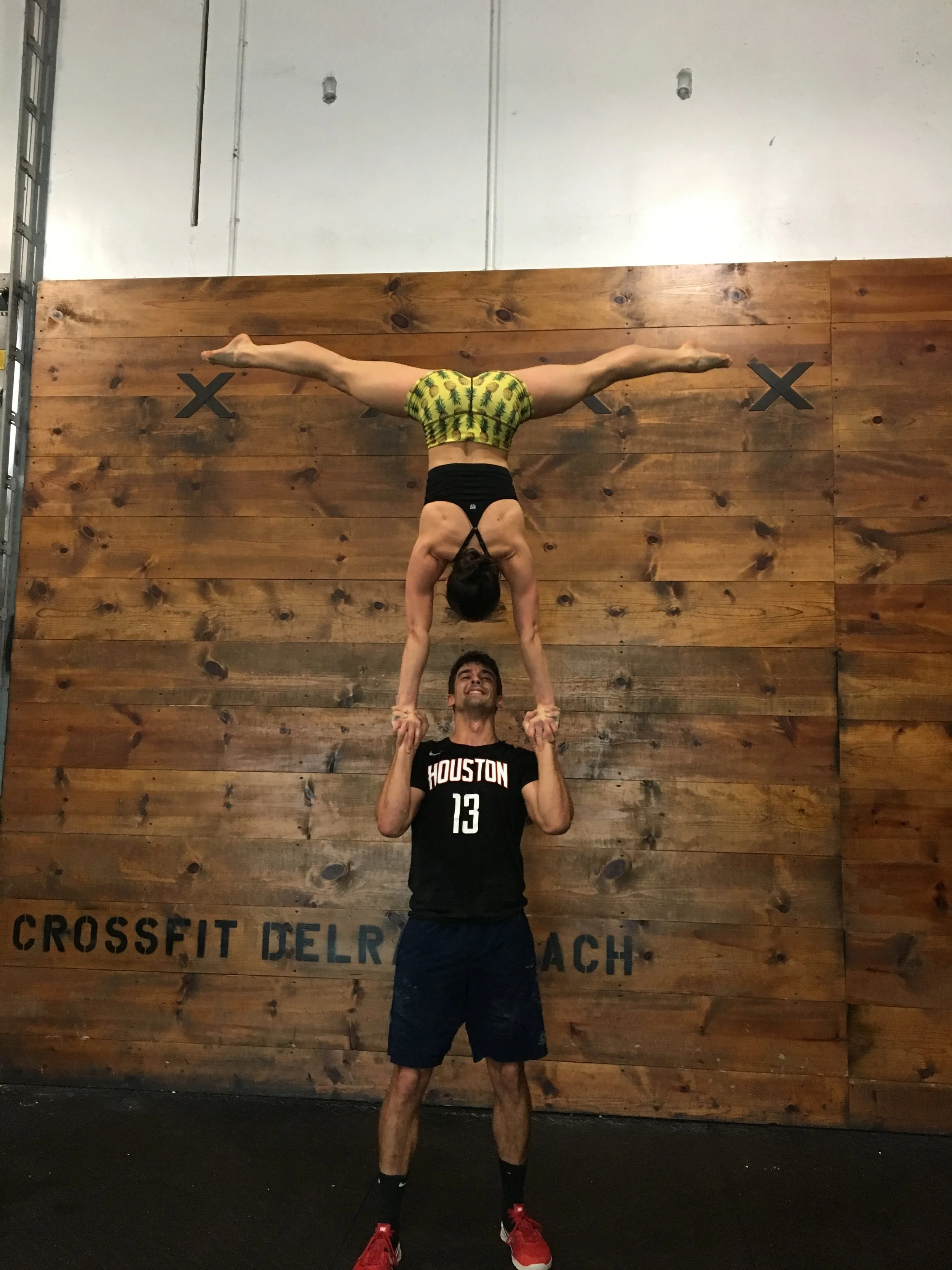 Jennifer and her boyfriend doing a standing acrobatics move called “hand to hand” after finishing a CrossFit workout during a recent vacation to Delray Beach.