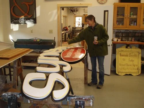 Mary putting the final touches on the sign