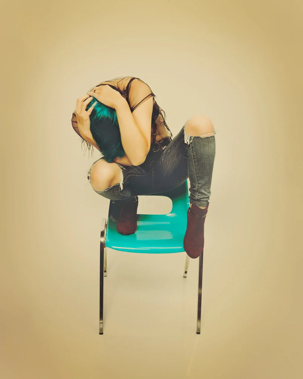  Self Portrait of Christine Lauzon sitting on a cyan chair. 
