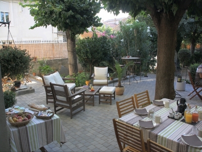 OUR FAMOUS BUFFET BREAKFAST IS SERVED AL FRESCO ON THE TERRACE UNDER THE TREES.