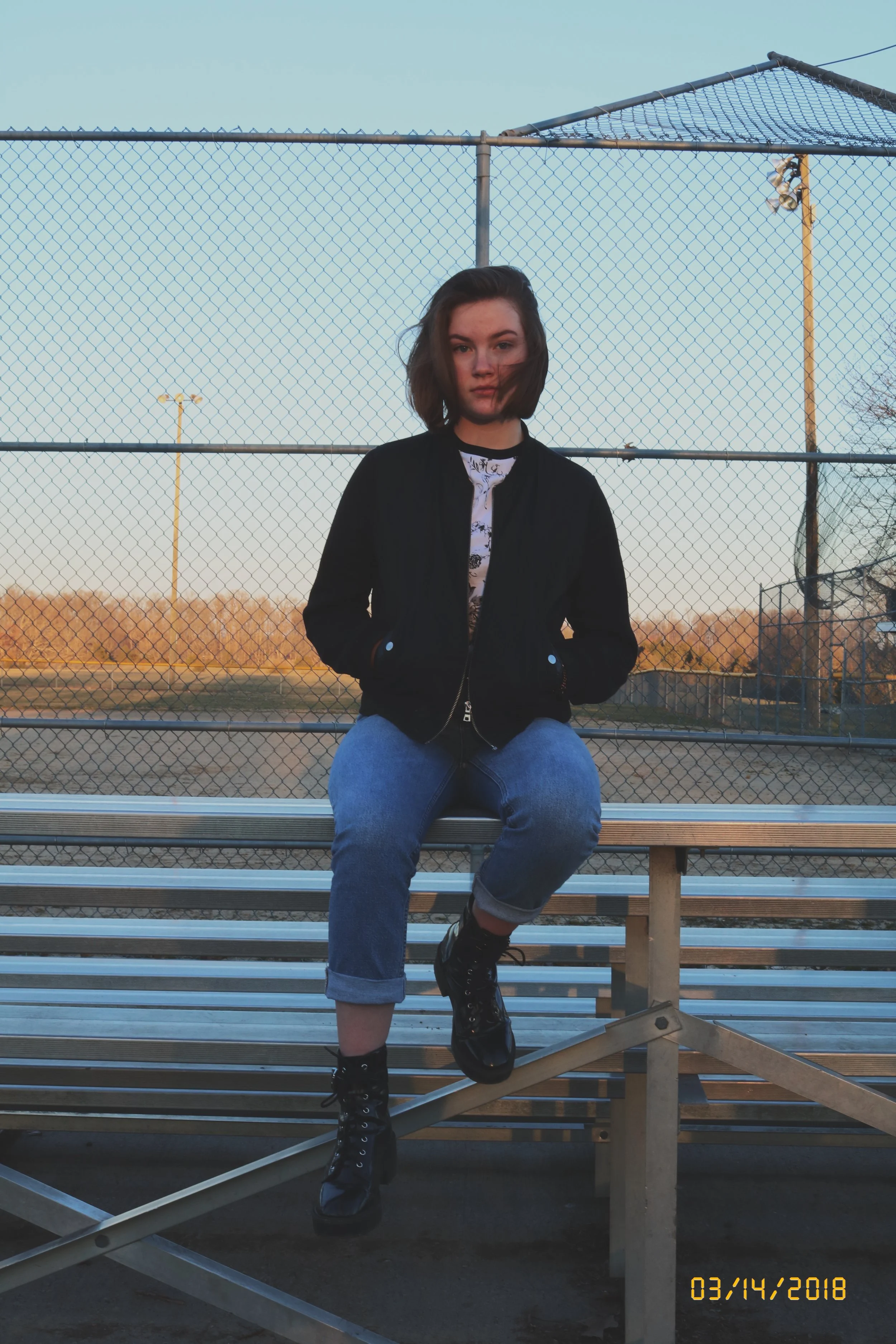 carly bleachers sitting.jpg