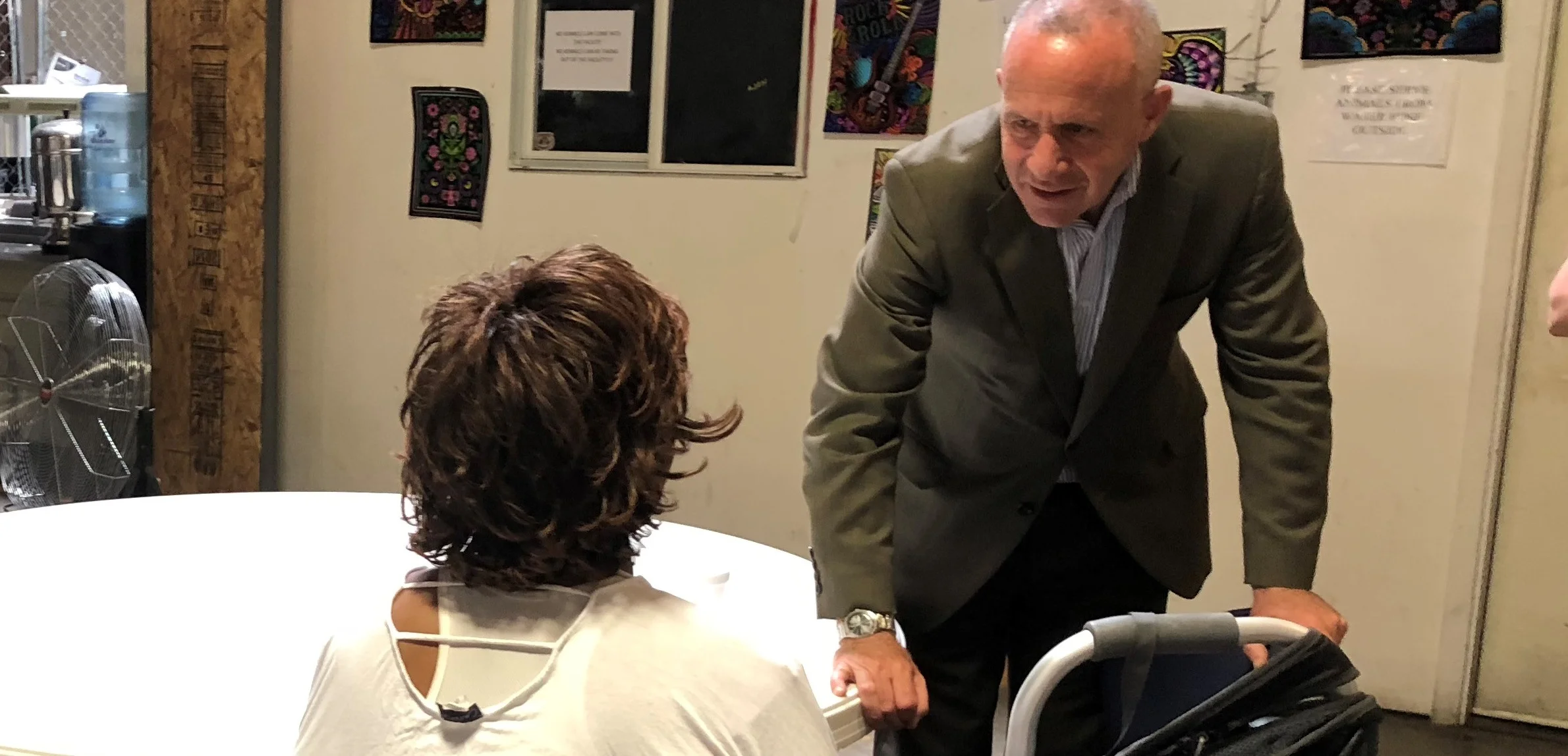 Mayor Steinberg visits with a guest in the city’s Railroad Drive triage shelter