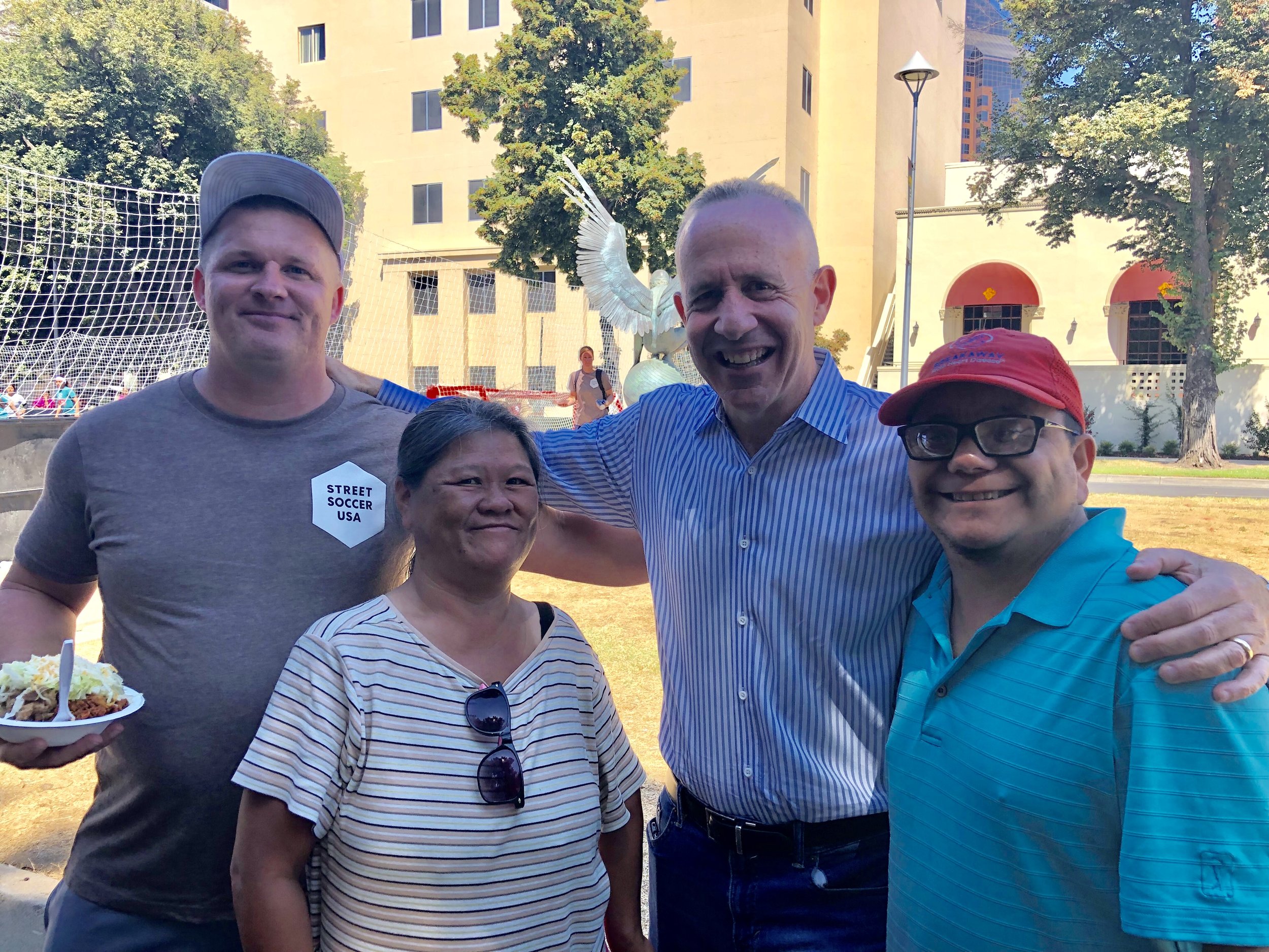 Mane and Felipe, second from left and far right, were homeless for nine years before entering the city’s Railroad Drive shelter. They now live in permanent housing.