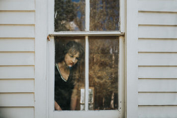 Window portrait of Kelsey Johnson by fine art portrait photographer Jaclyn Le