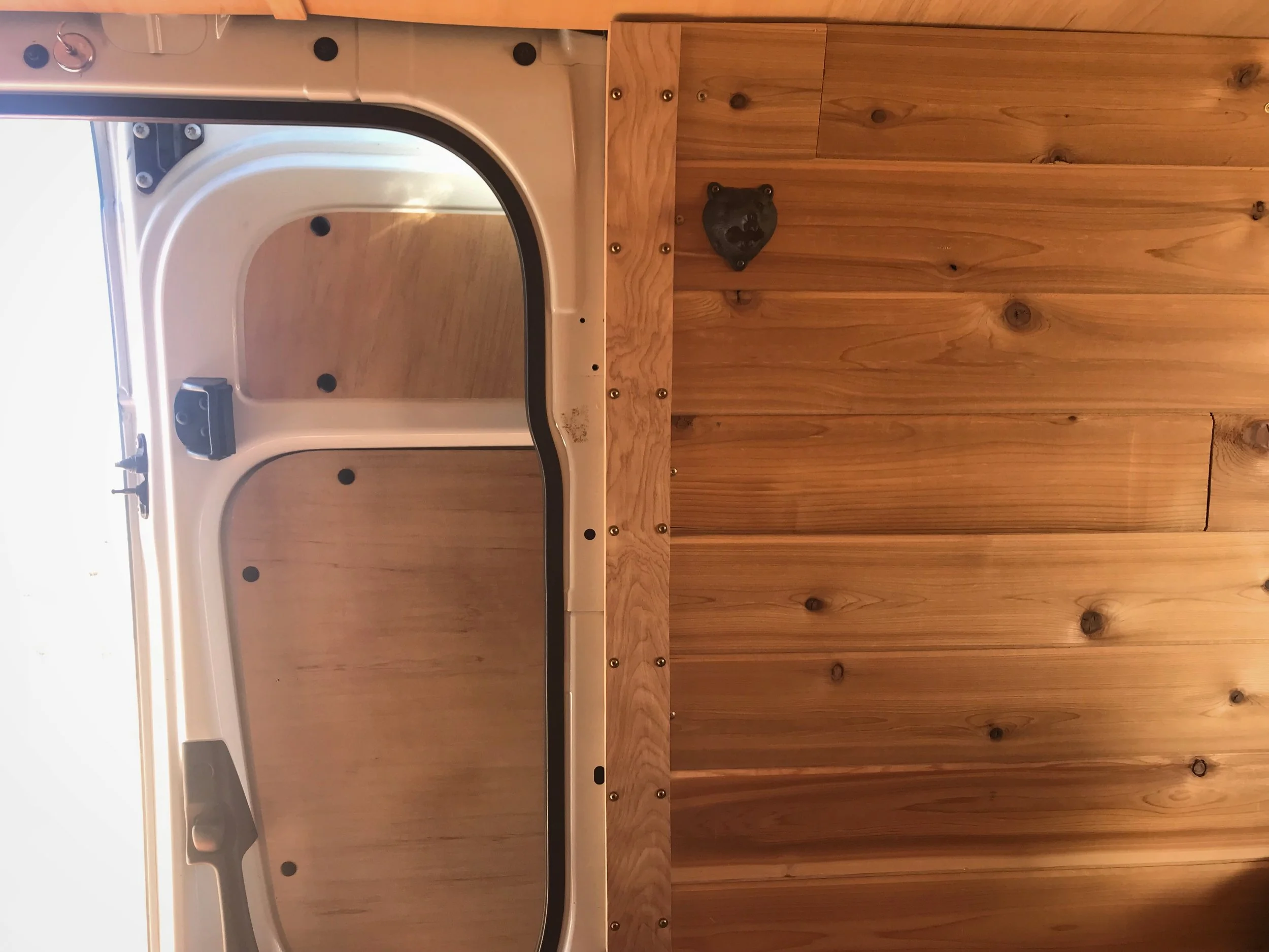 This panel hides the thick bundle of wires that run from our solar panels to our battery and from the fuse box to the lights and fan.