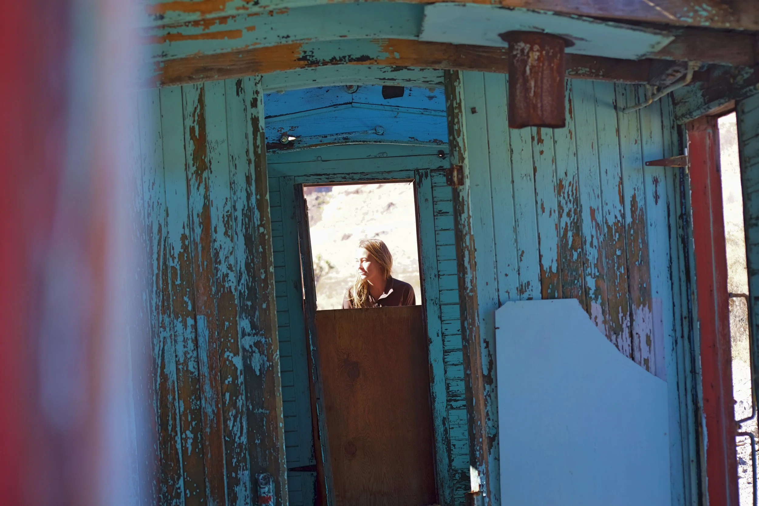 A boxcar has been left near the train depot.