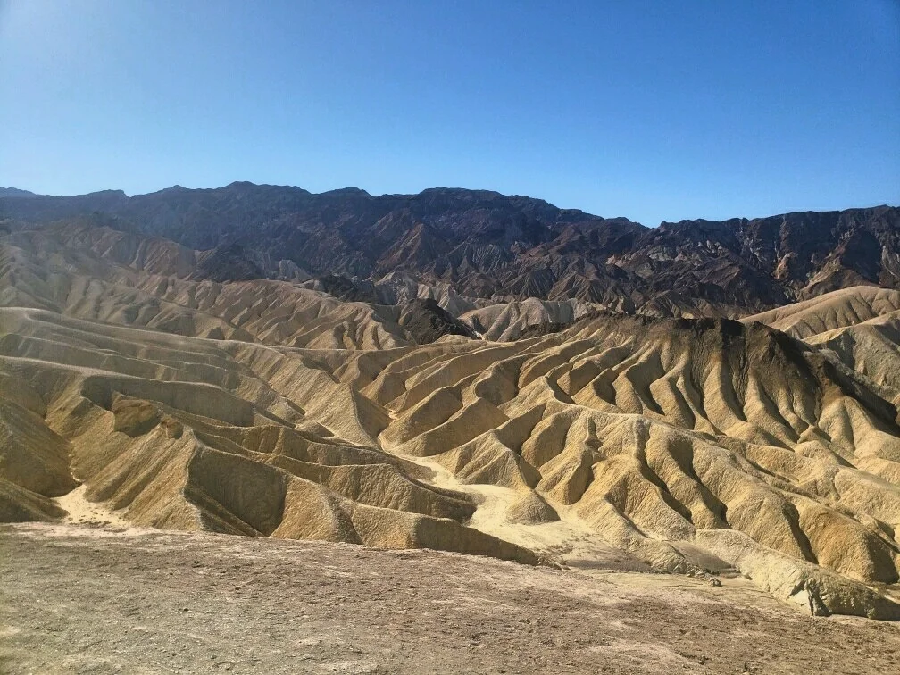 The eroded, white badlands of Zabriskie Point by day.
