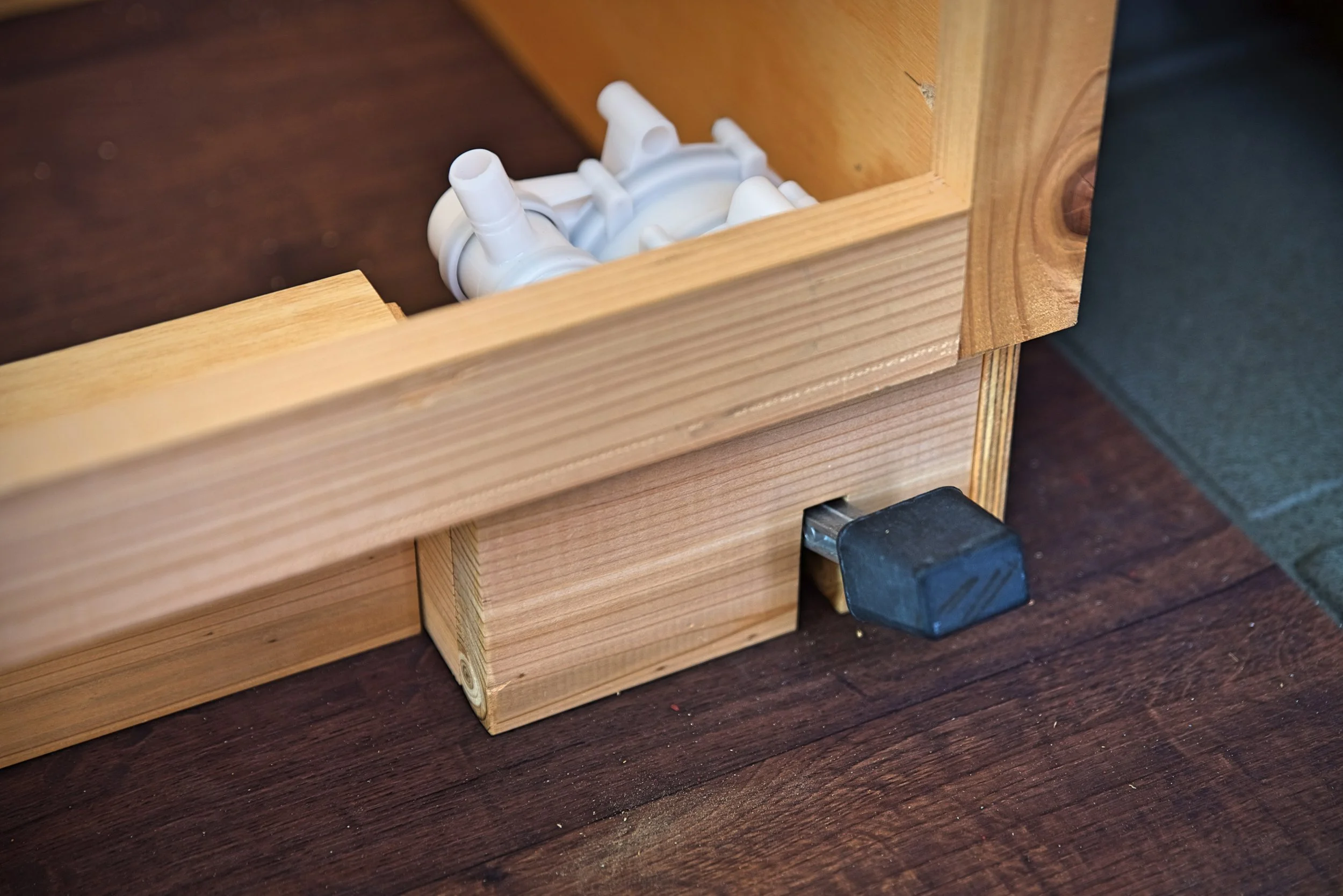 The ugly white plastic pump is hidden within the toe kick of our cabinetry.