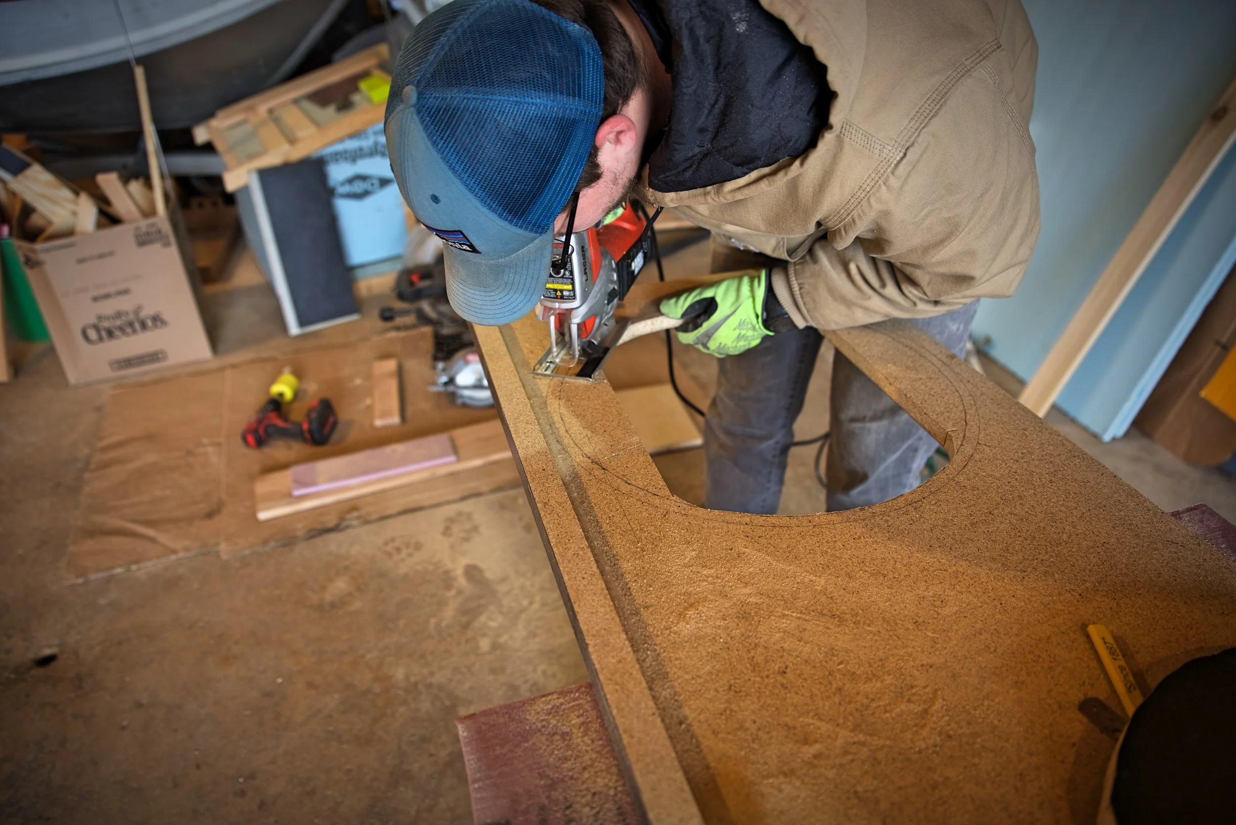 Ian using a jig saw to cut the circular hole for our sink.