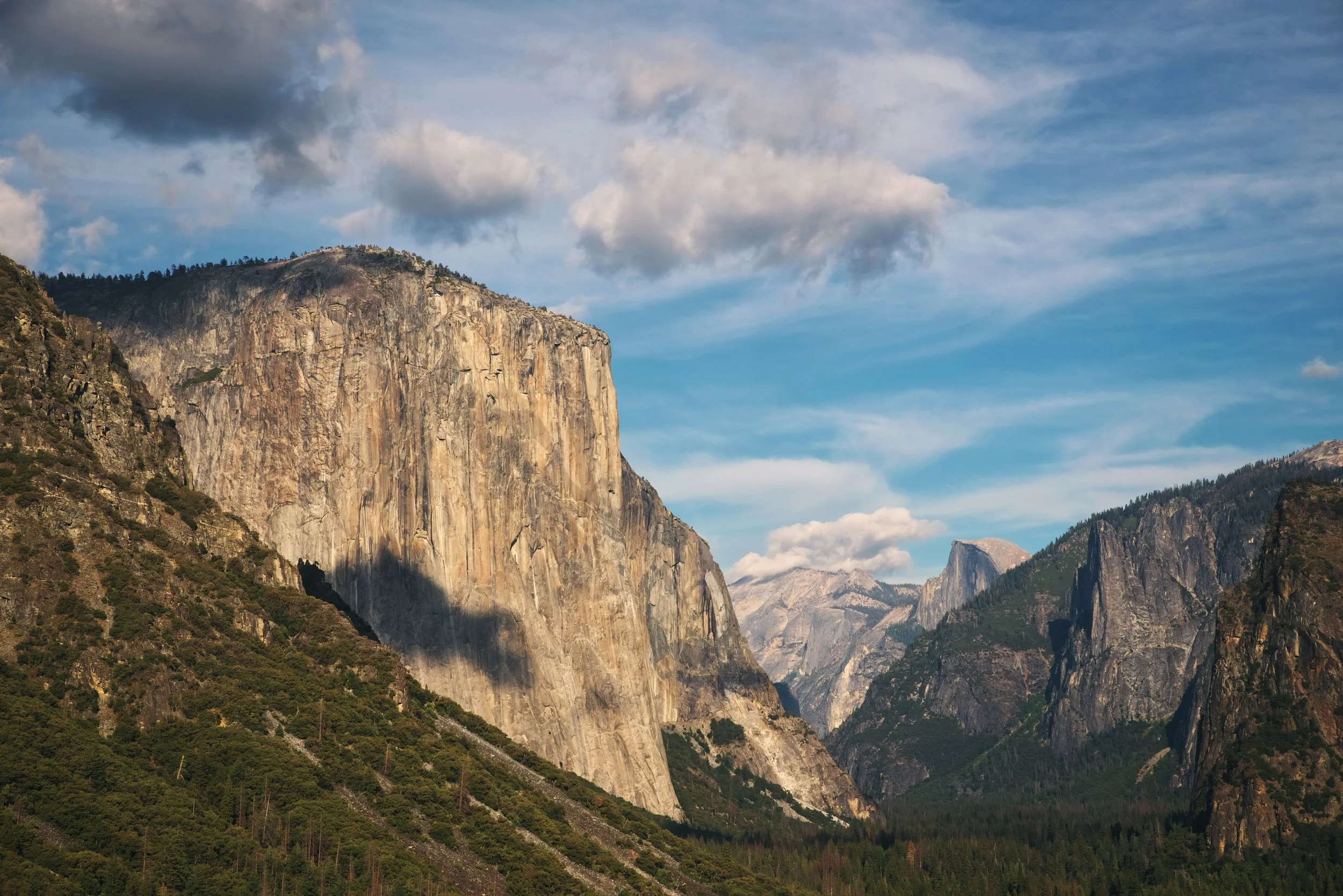 From the Tunnel View Overlook, you get a really amazing view of El Capitan and Half Dome peaks out from behind more mountains further down Yosemite Valley.