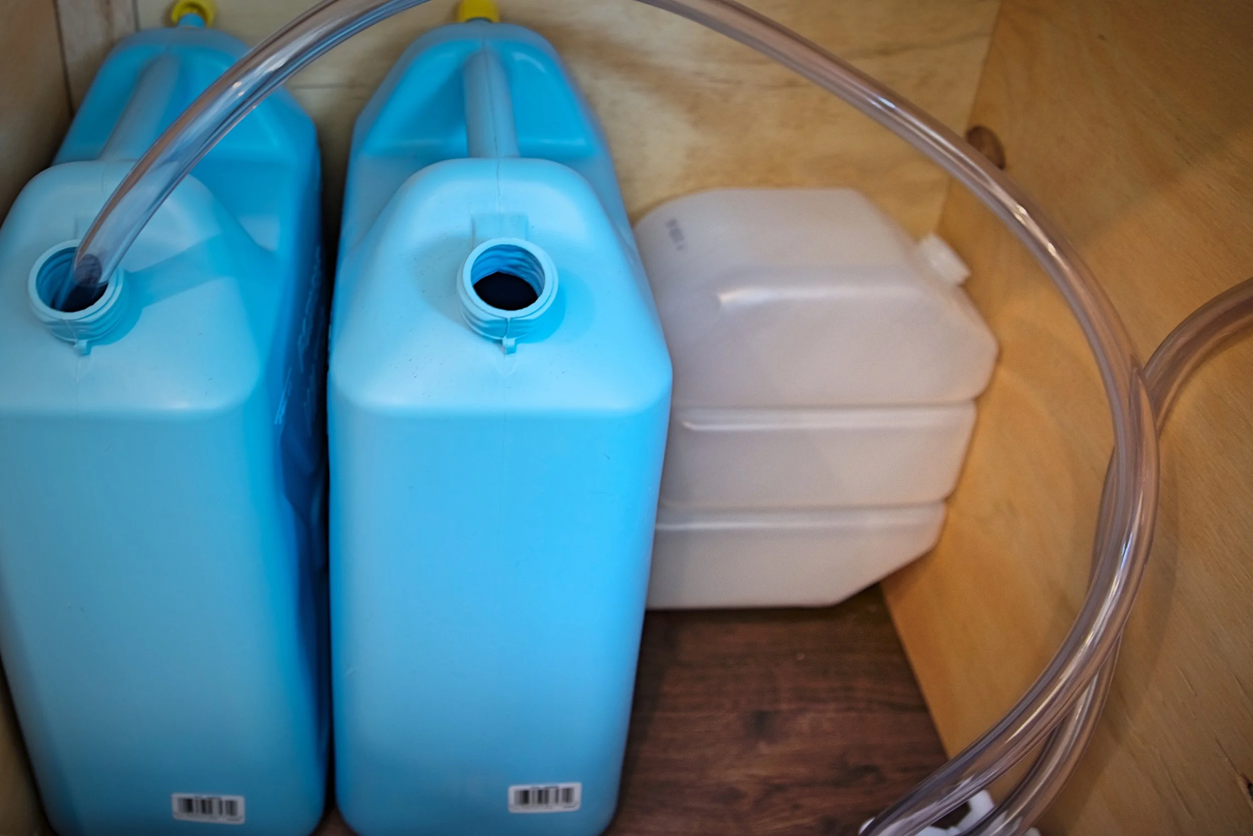 We capture our gray water using a 2.5 gallon disposable drinking water container.