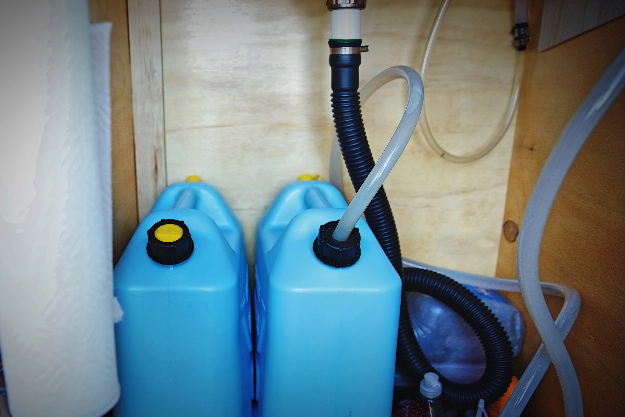 We put a loop in our flexible drain pipe to act as a P-trap. You can also spot a grimy gray water jug in this photo.