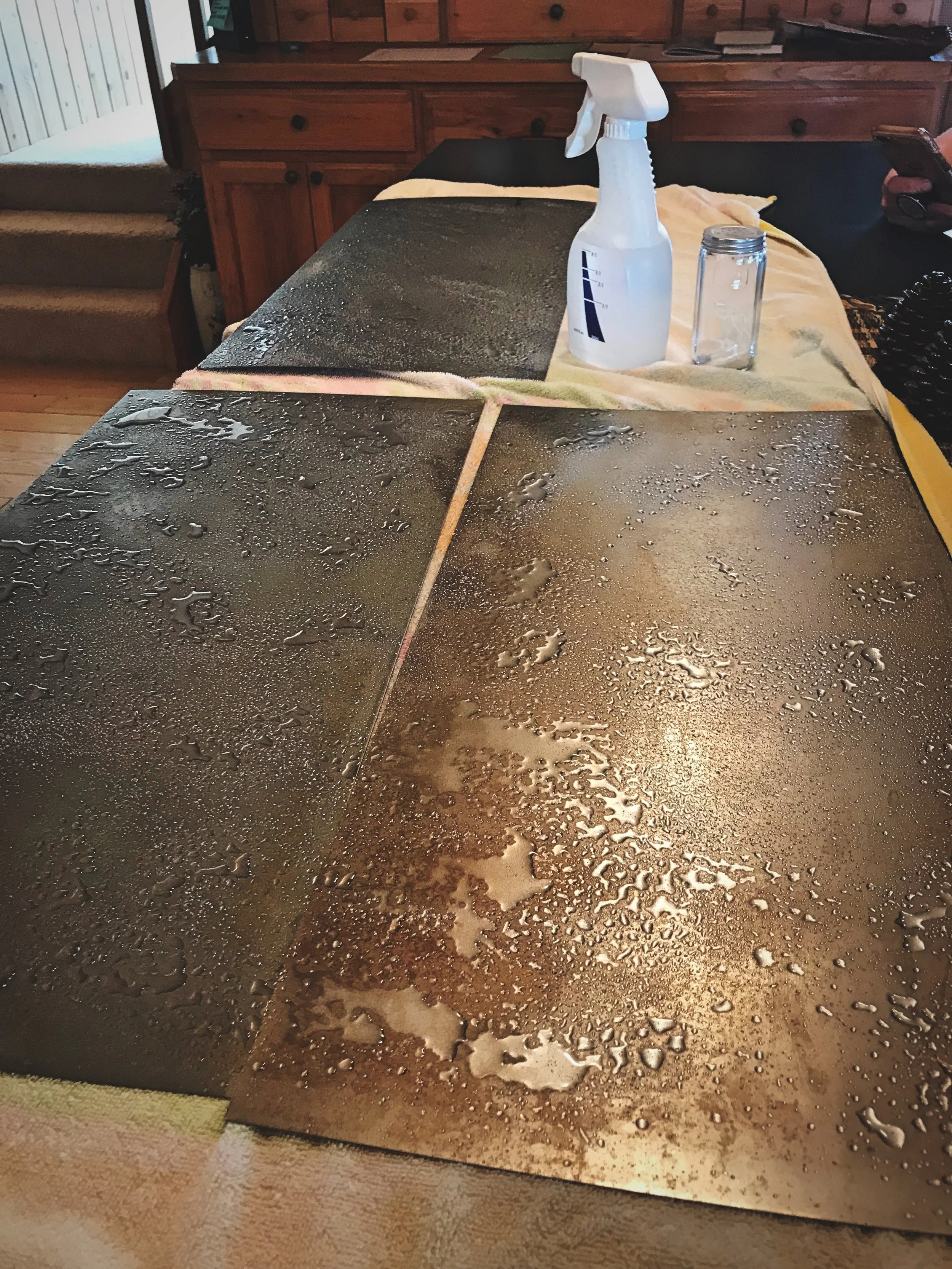 To create a rusty patina for our backsplash, we catalyzed the oxidation using vinegar and salt.
