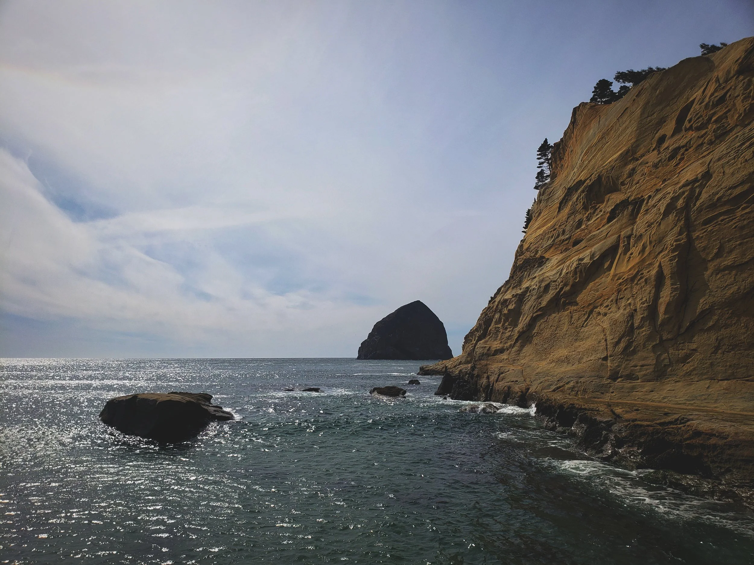 Haystack Rock has protected the soft sandstone cliffs of Cape Kiwanda from wave action while other areas have eroded completely.