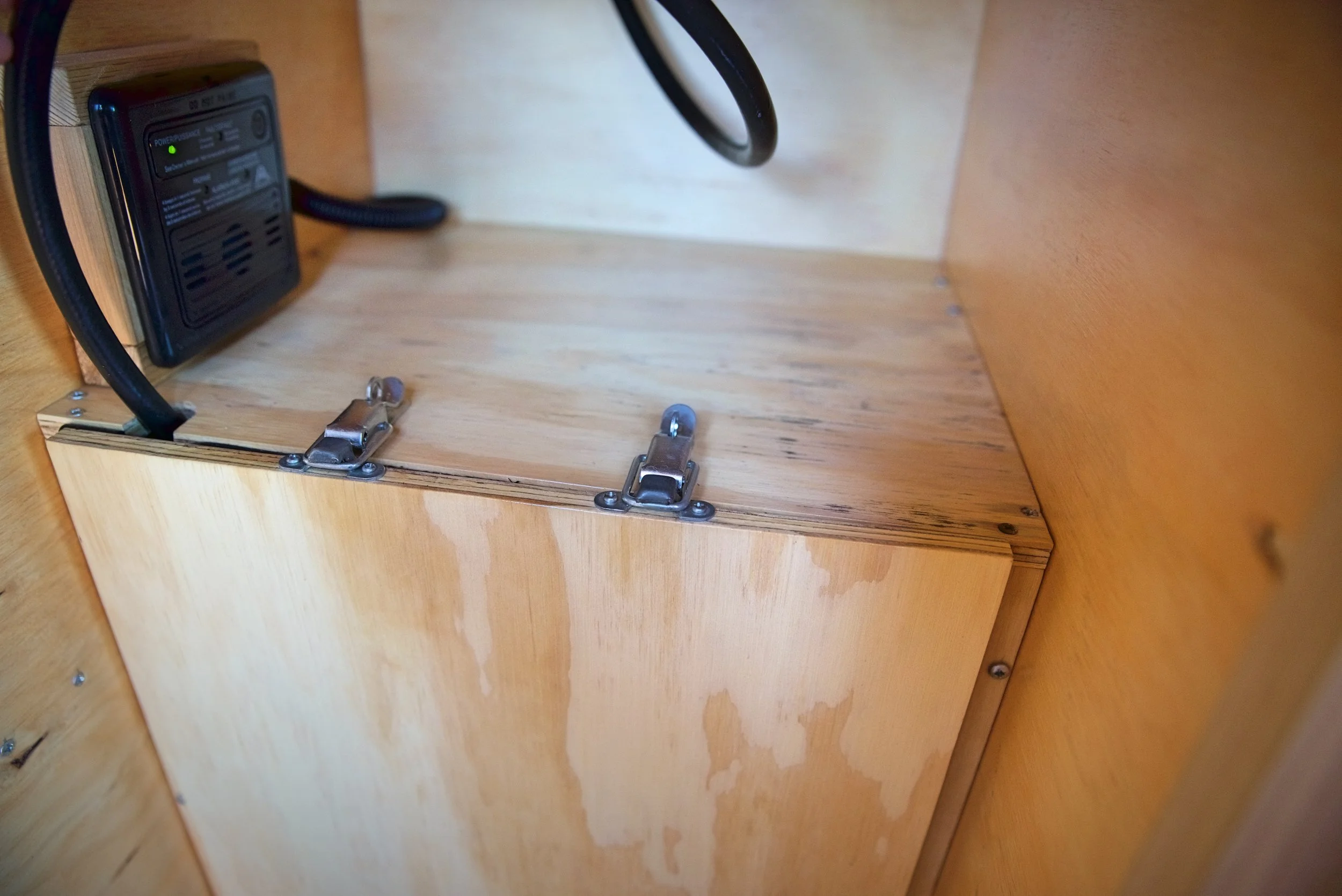 To turn our propane on when cooking, all we have to do is pop these two latches open.