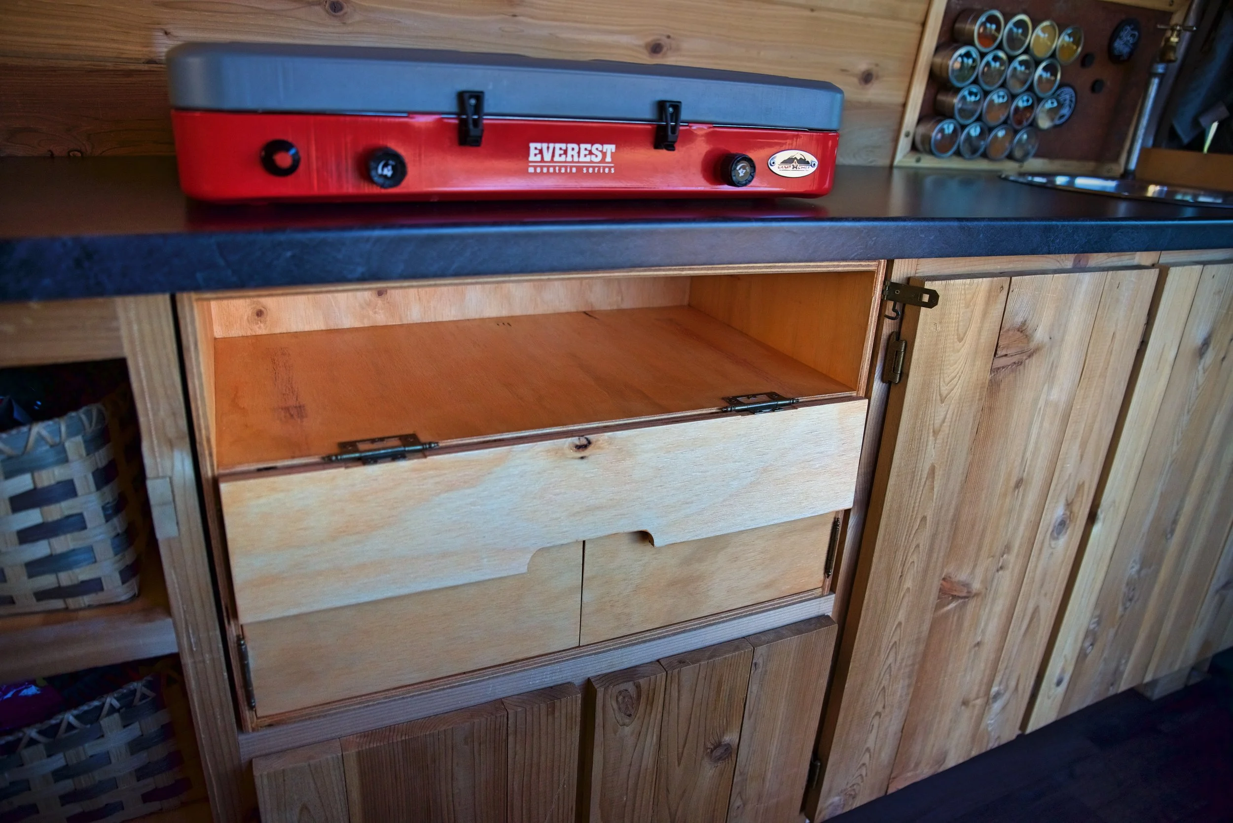Cooking inside the van is easy with the chuck box. All we have to do is pull the stove out and put it on the counter.