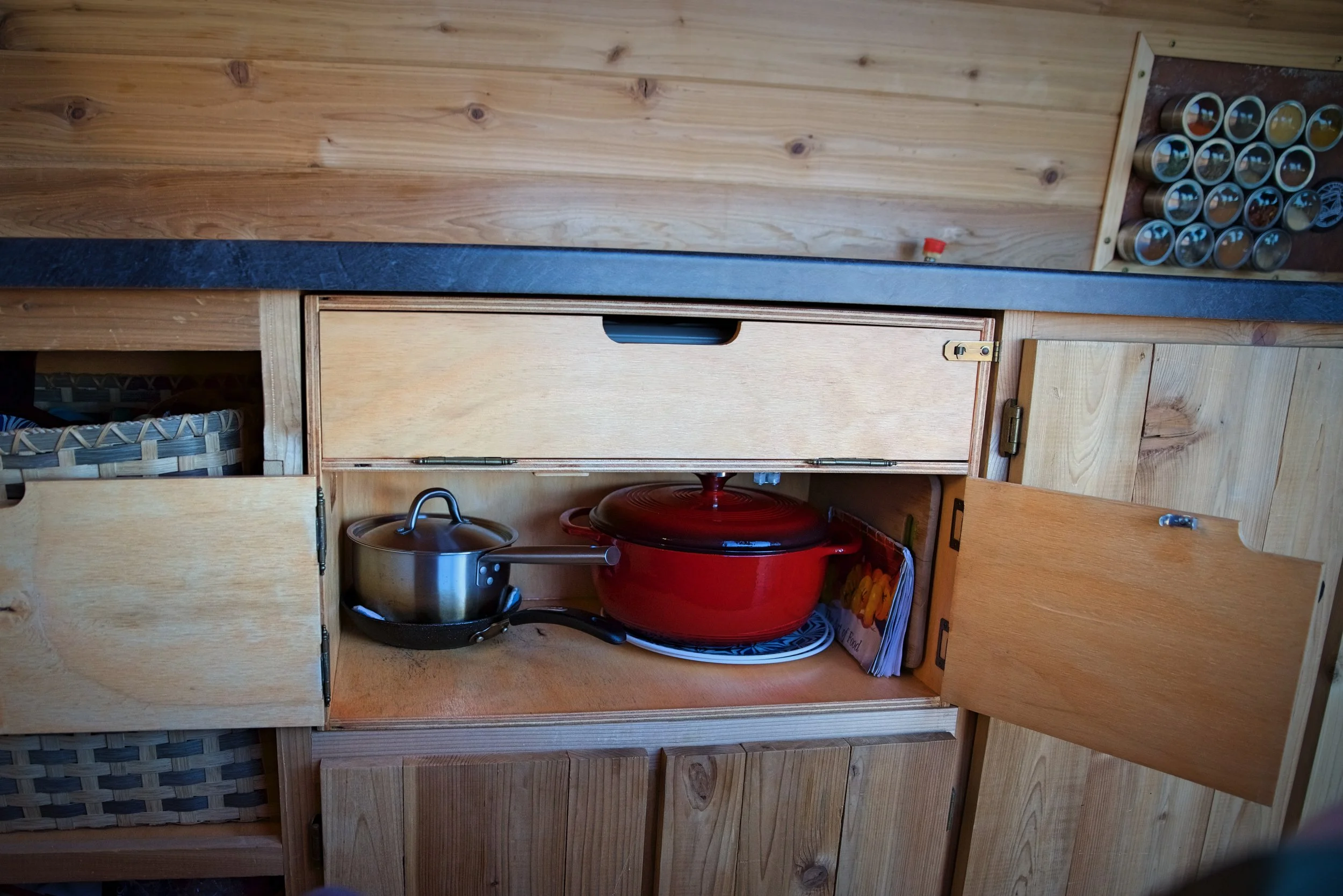 The bottom compartment of our chuck box holds our dishes and pots and pans.