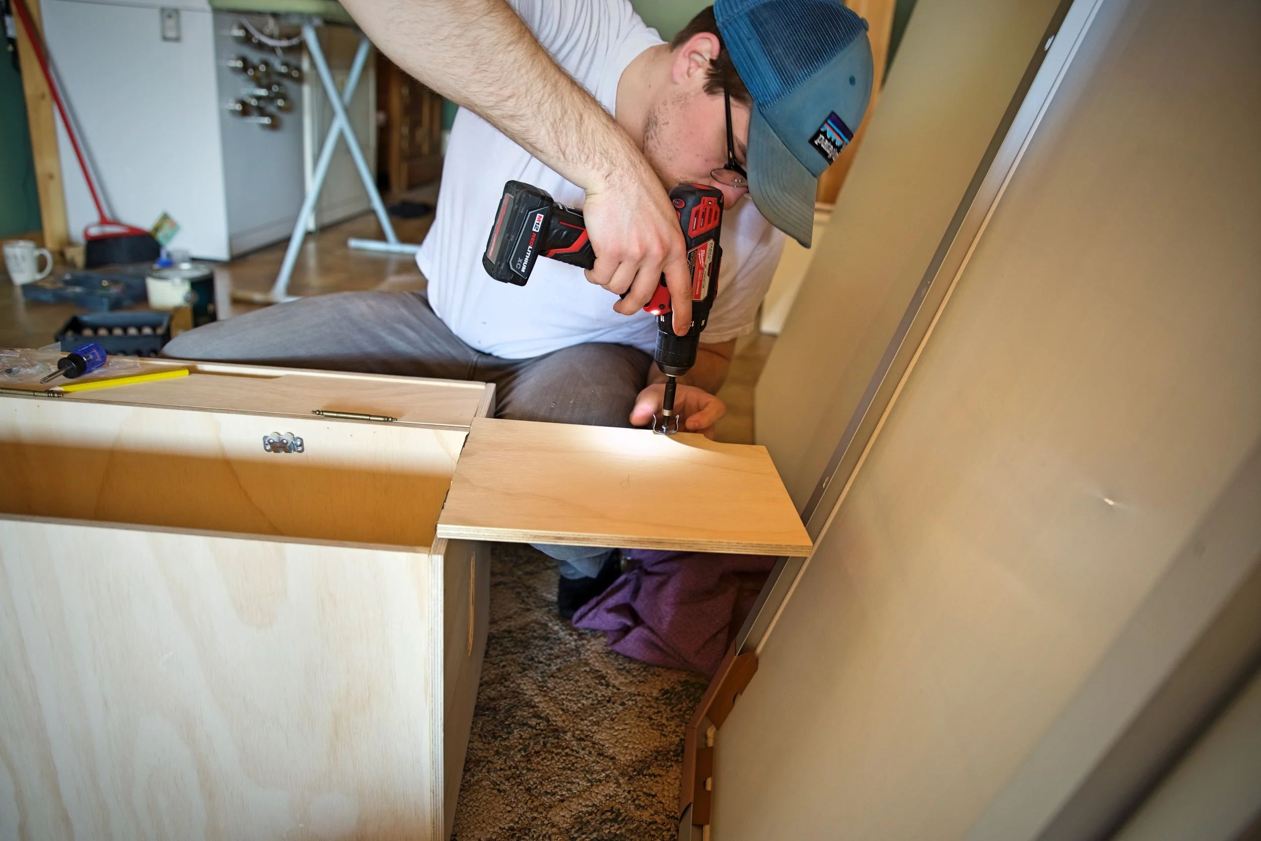 Ian installs a small roller catch on the inside of our chuck box.