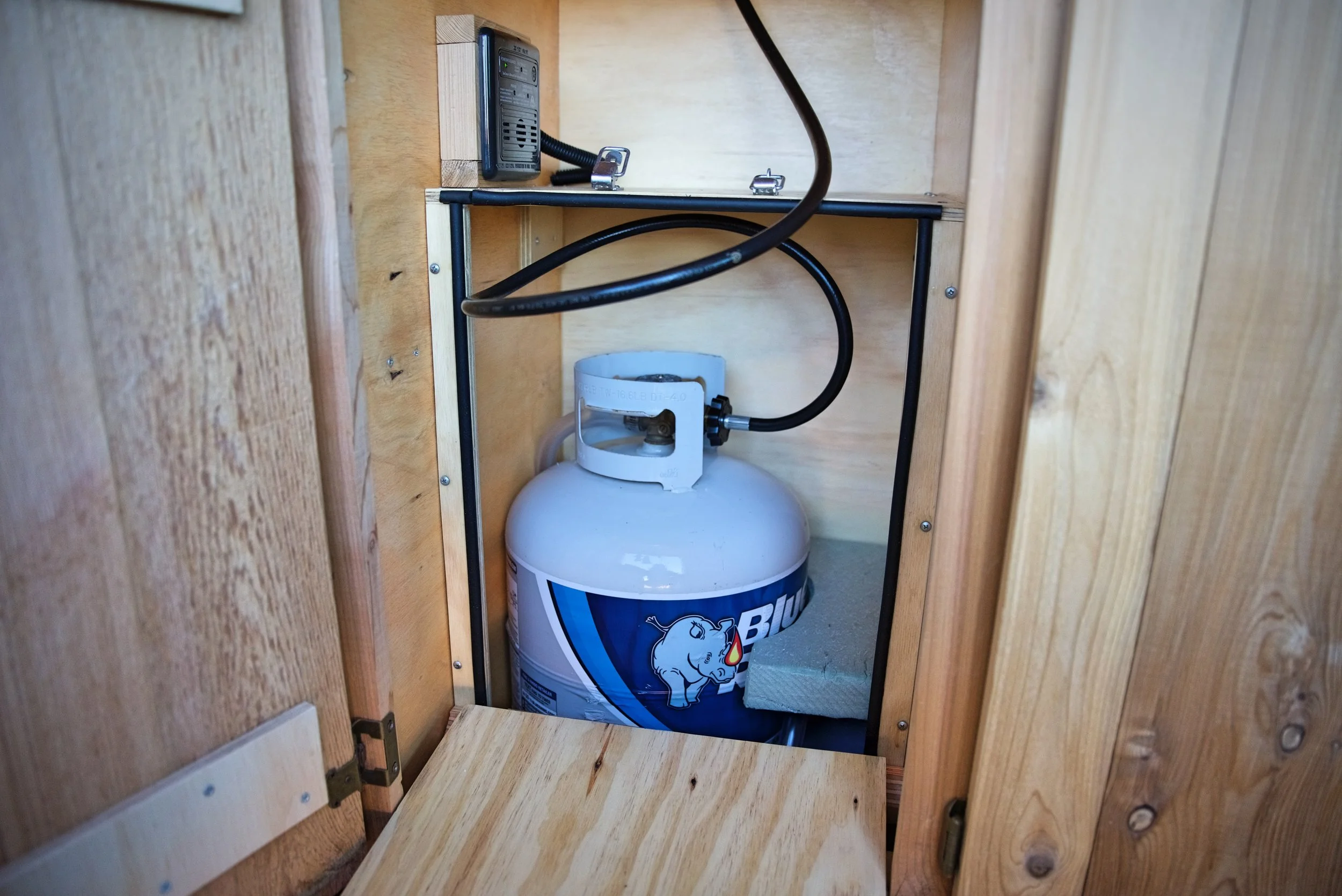 Our propane locker keeps our propane tank secure and forces any leaking propane out a hole in the bottom of the van rather than allowing it to leak into our living space.