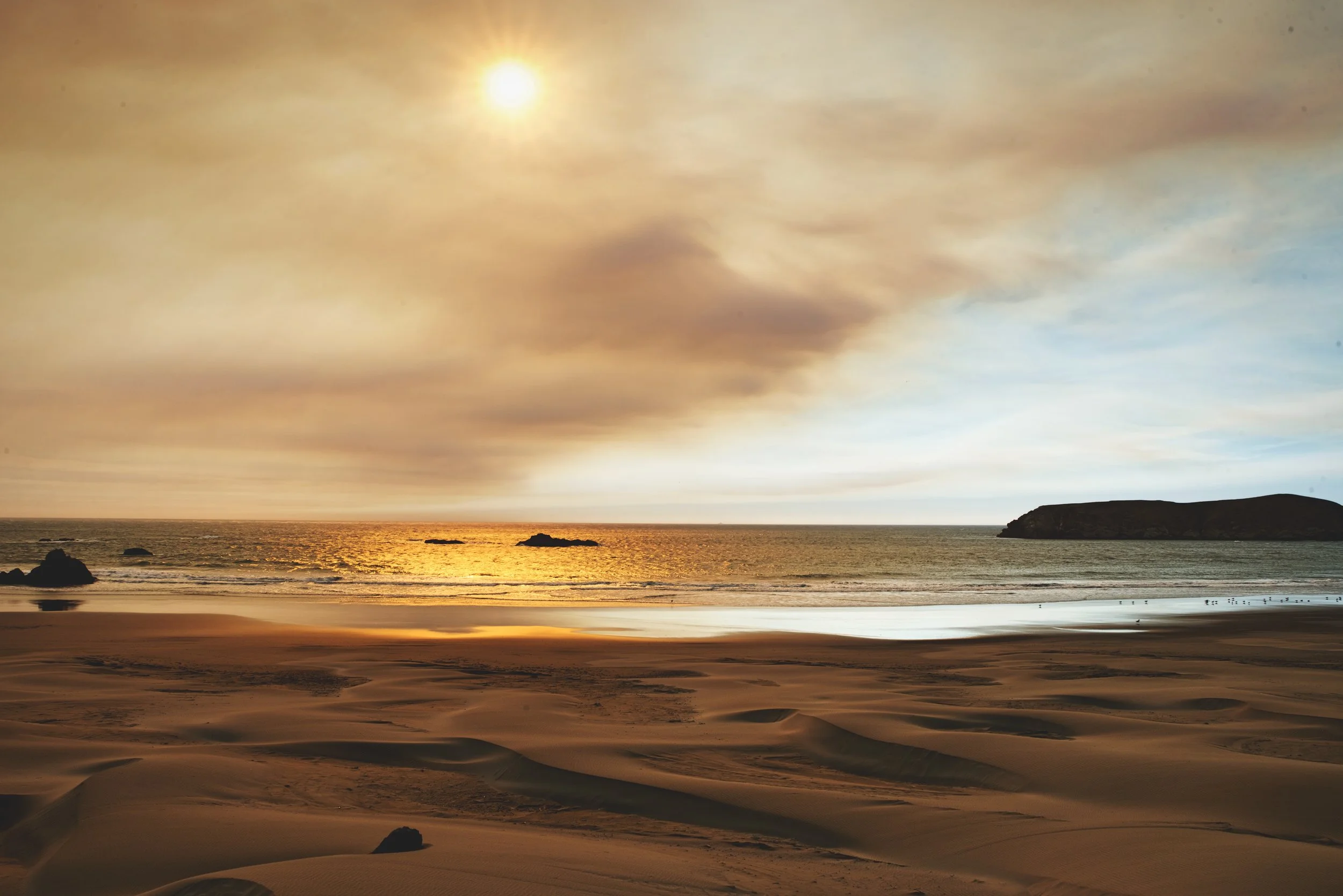 The smoke drifting north from fires inland in Oregon and California stained the otherwise blue sky orange.