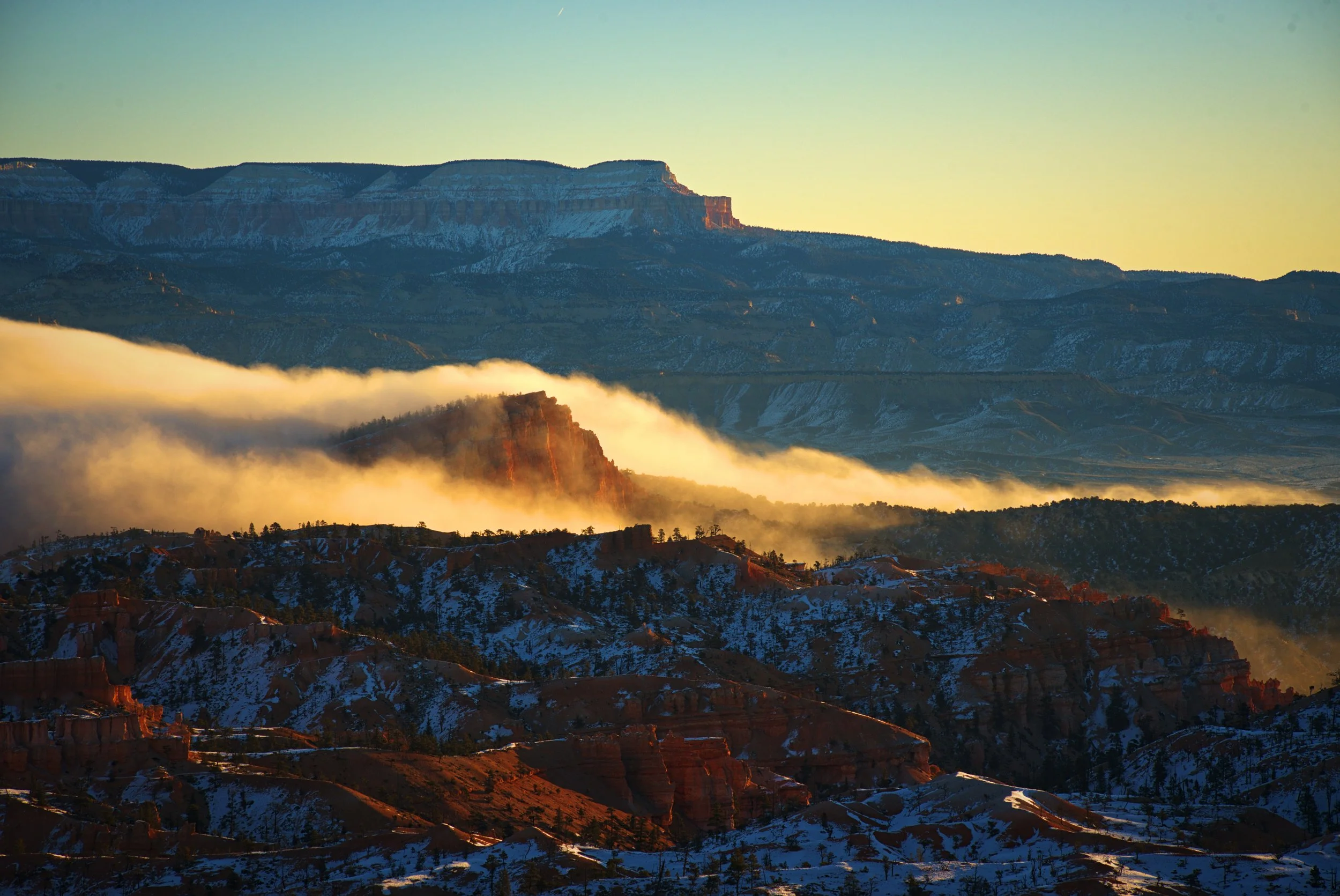 A cloud inversion drifts in over the Sinking Ship formation at dawn.