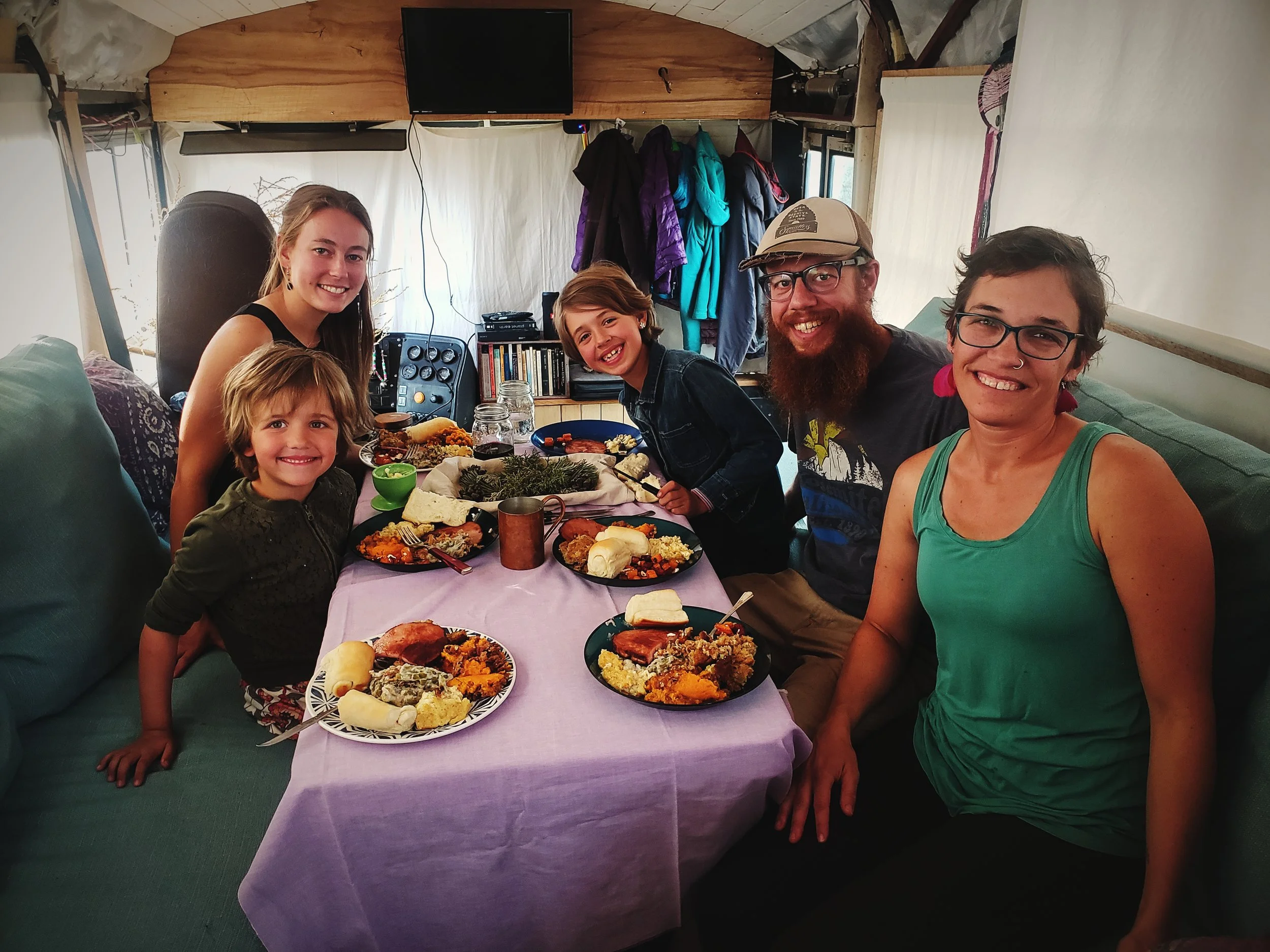 Here we are enjoying Thanksgiving dinner in their cozy, wood-heated bus home.