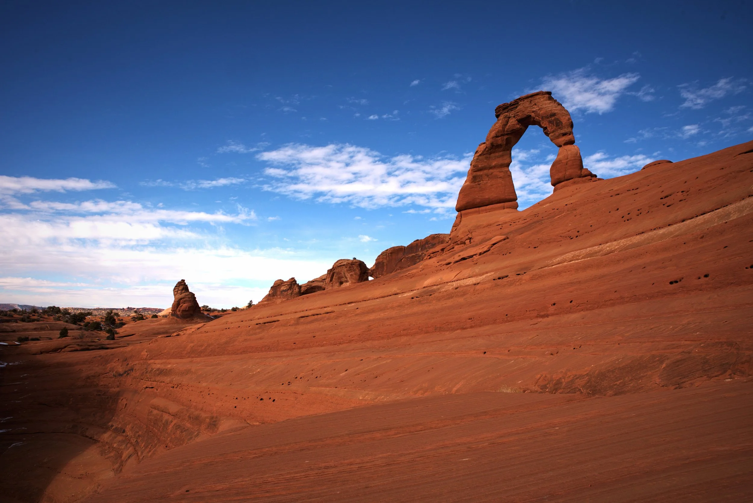 Ian scrambled behind the arch down this sloped sandstone to snap these photos.